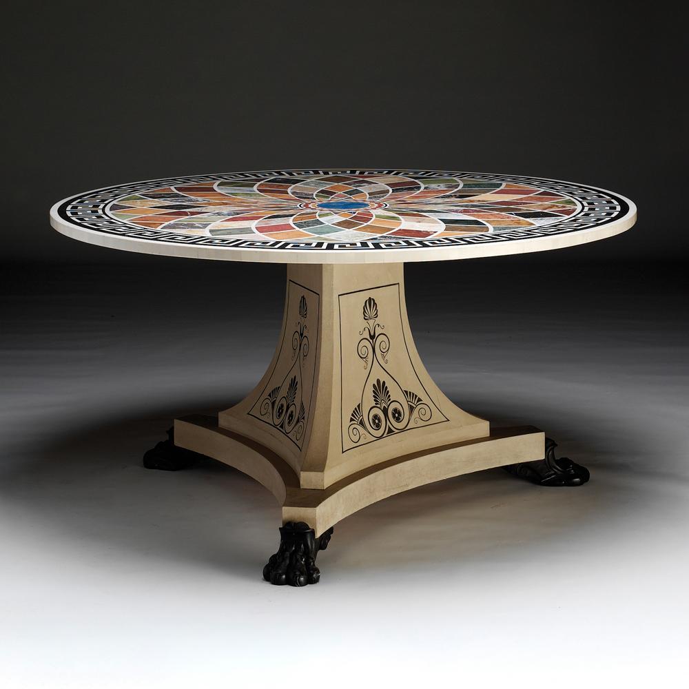 An important Regency design centre table with a magnificent inlaid specimen marble top surrounded by a Greek key motif surmounting a decorated triform base and resting on ebonised lion paw feet.

Bespoke sizing, design adaptations and finishing