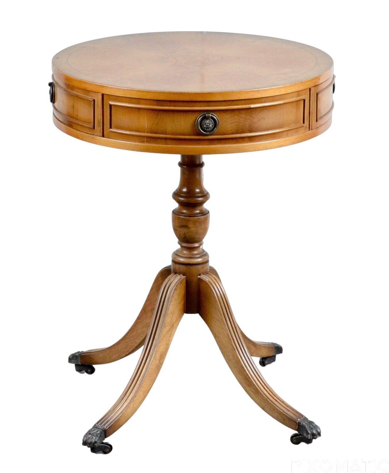 We are delighted to offer for sale this fine quality yew drum table by N. Norman LTD London.
This beautiful table has two drawers and is fitted with brass ring handles, raised on a turned column, and out swept reeded legs with claw feet and
