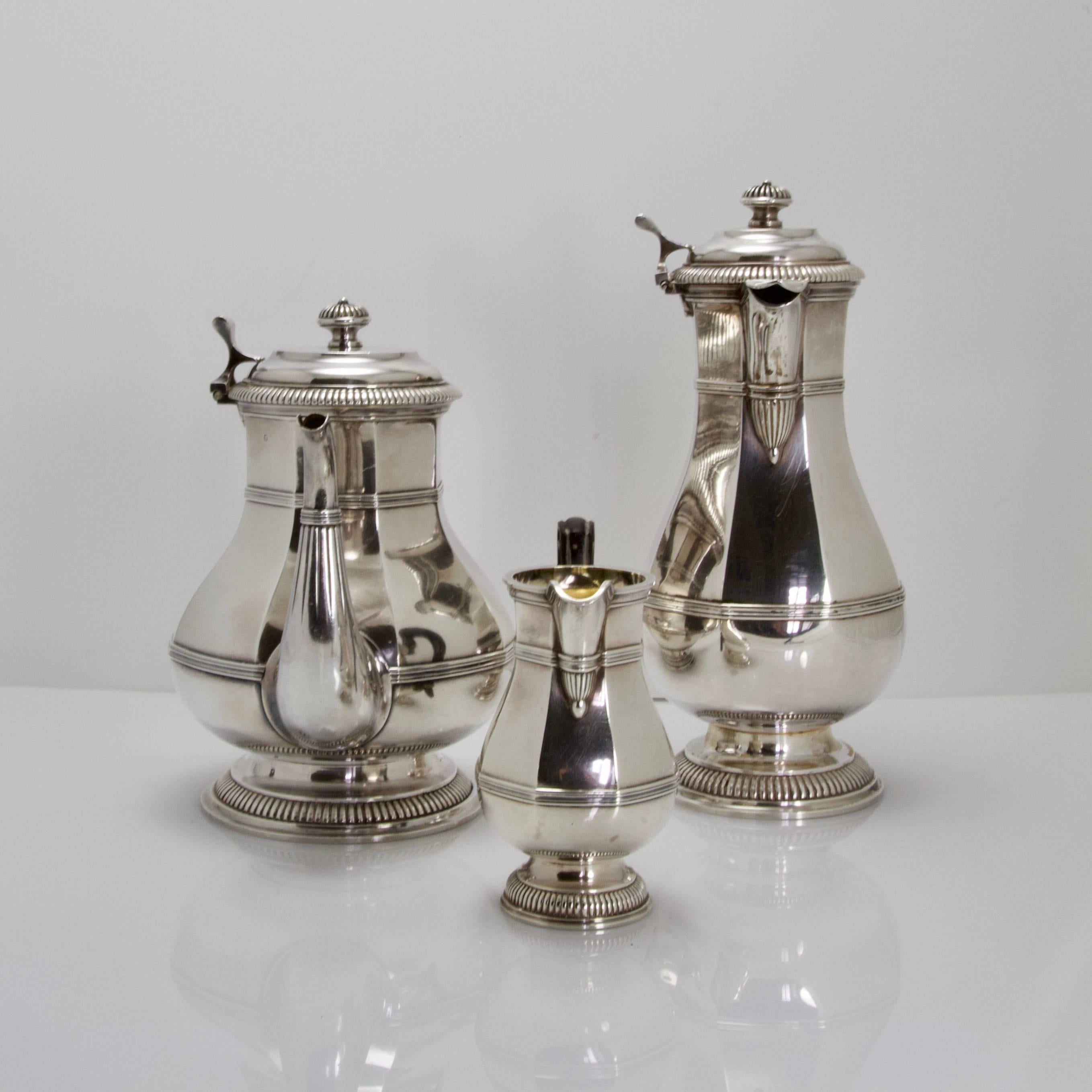 Baluster shaped on small pedestal three pieces comprising a tea pot, a coffee pot and a creamer. Straight body 