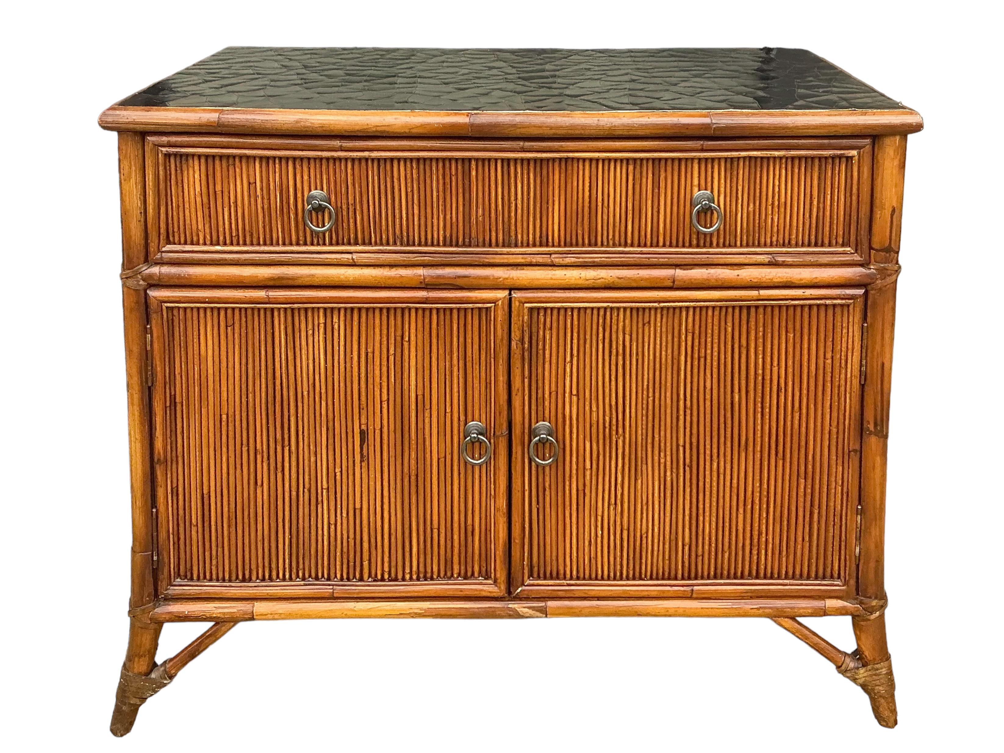 This is a pair of bamboo and black lacquer cabinets by the Milling Road subdivision of Baker Furniture Company. The tops are a distressed black lacquer, while the bases are bamboo with black lacquer inset side panels. They are marked and very