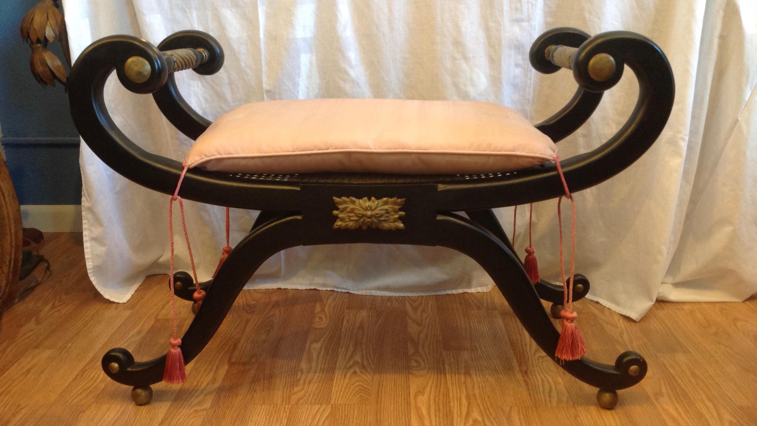 An elegant bench - Curule style with gilt appointed handles.
The bench has a caned seat fitted with s tassels appointed loose silk cushion.
Fine continental styling.