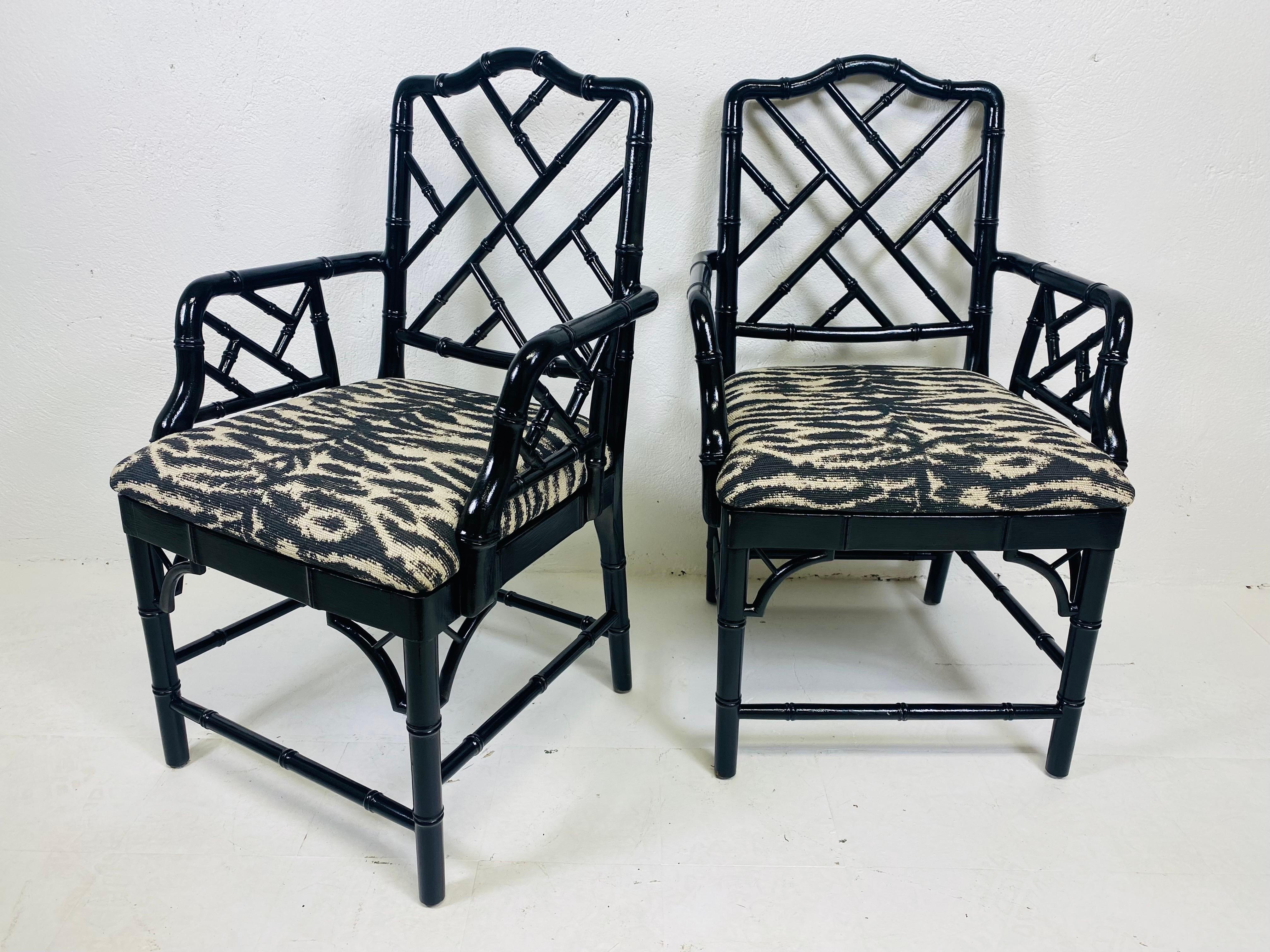 Wood Regency style black Lacquered faux bamboo arm chairs/pair For Sale
