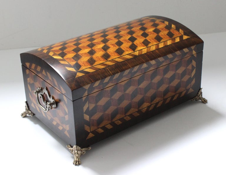 This stylish and chic English Regency style domed box with its marquetry woods and brass hardware dates to the 1980s-1990s and was created by Maitland Smith.