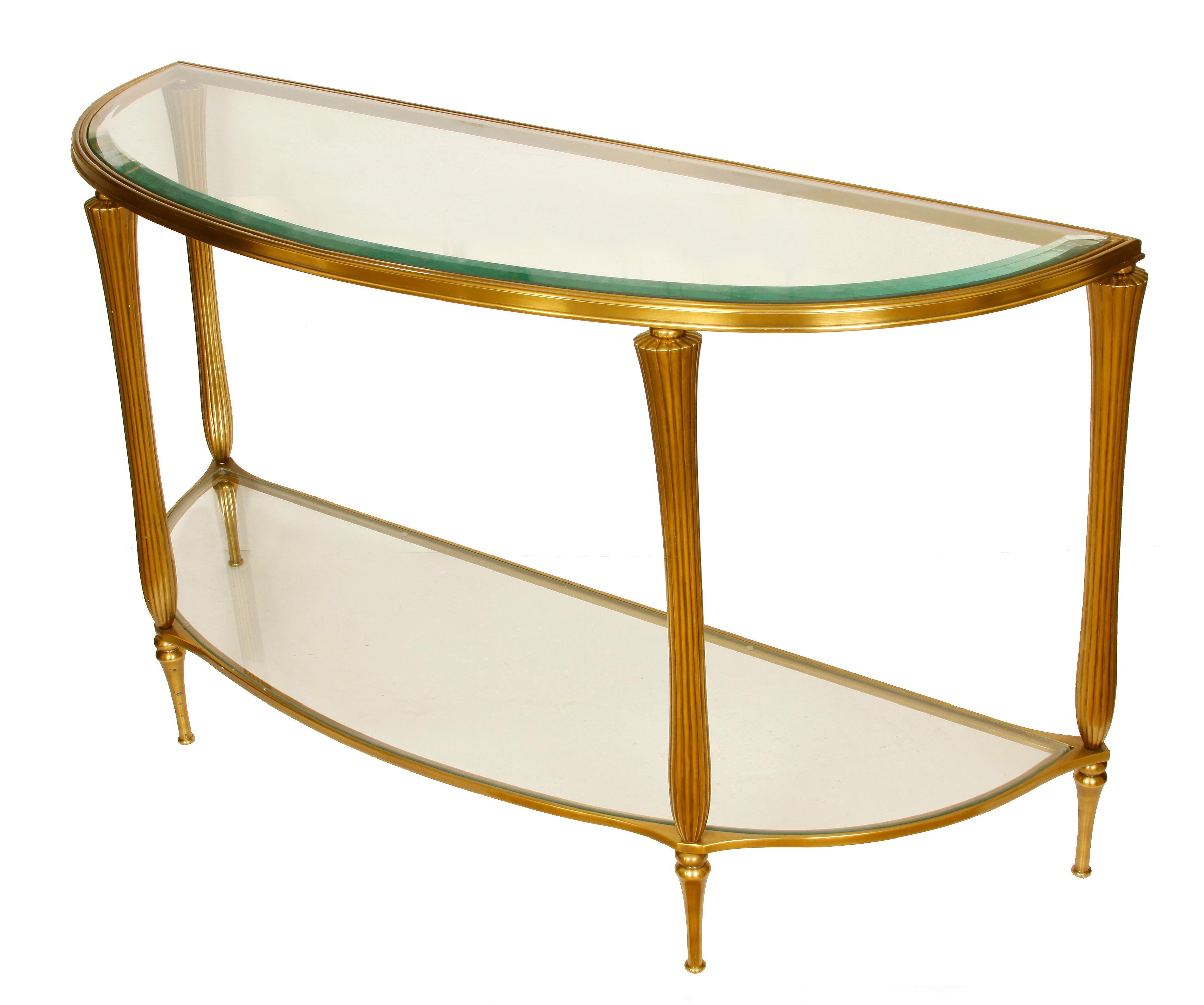 Regency style brass and glass demilune console, glass top and brass reeded legs.