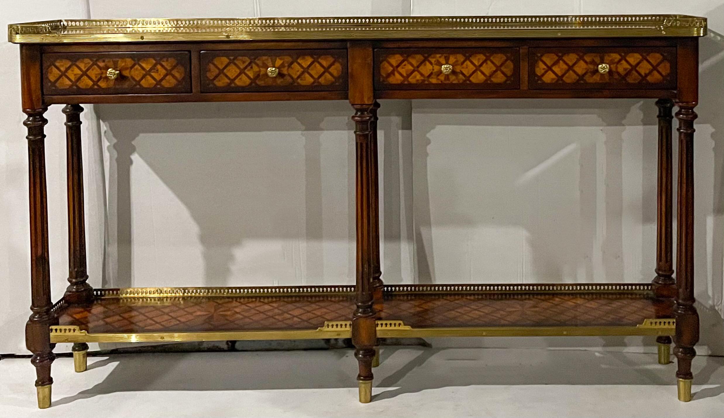 This is a regency style mahogany inlaid console table with brass gallery attributed to Theodore Alexander. It is in wonderful condition and dates to the later part of the 20th century.