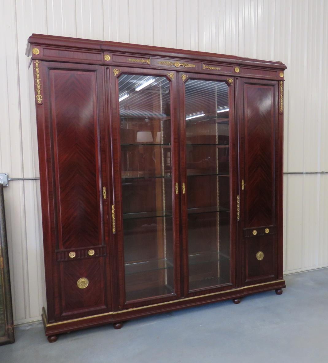 Regency style brass mounted 4-door breakfront. Centre glass doors each contain 5 glass shelves. The doors on each side have 5 shelves.