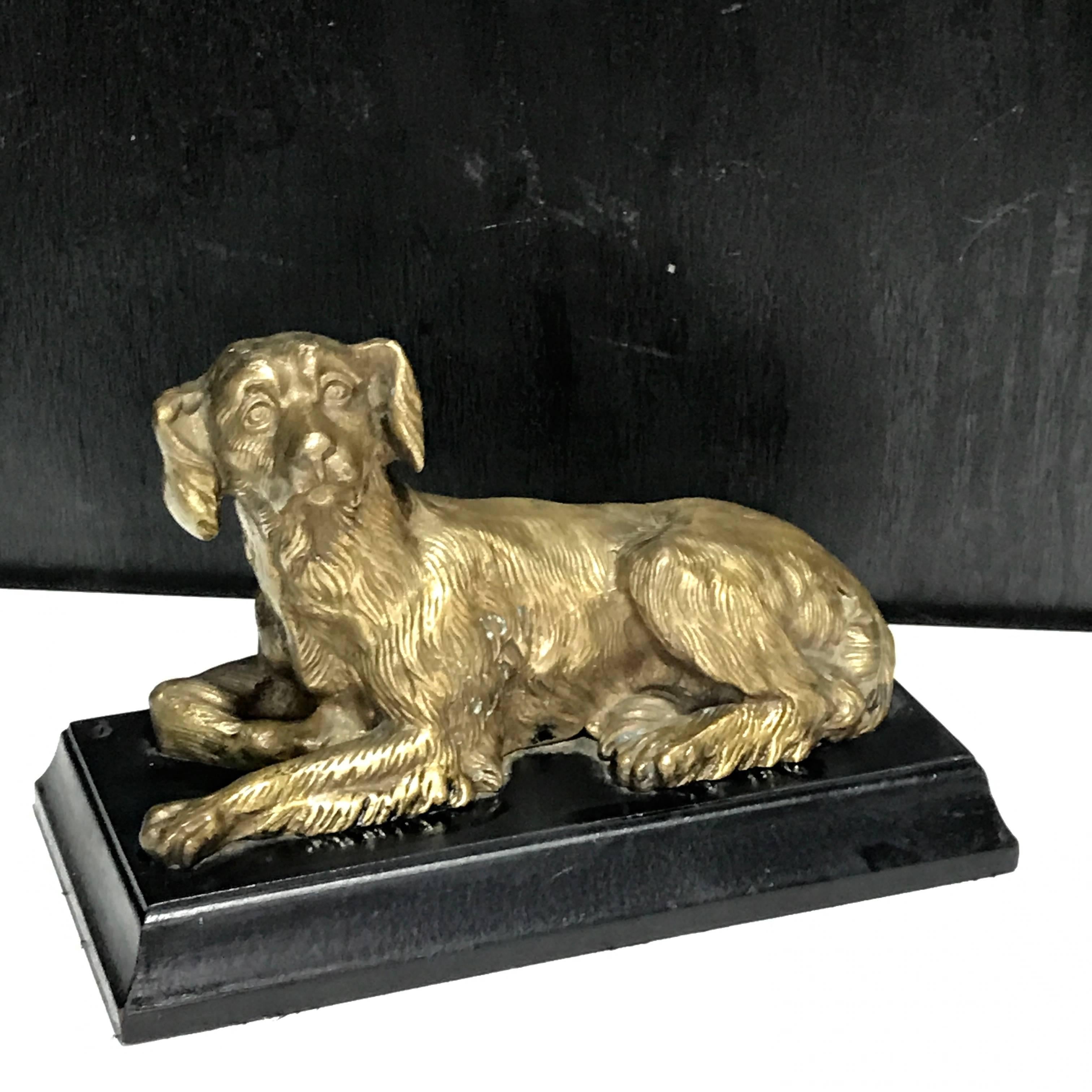 Regency style bronze figure of a recumbent dog.