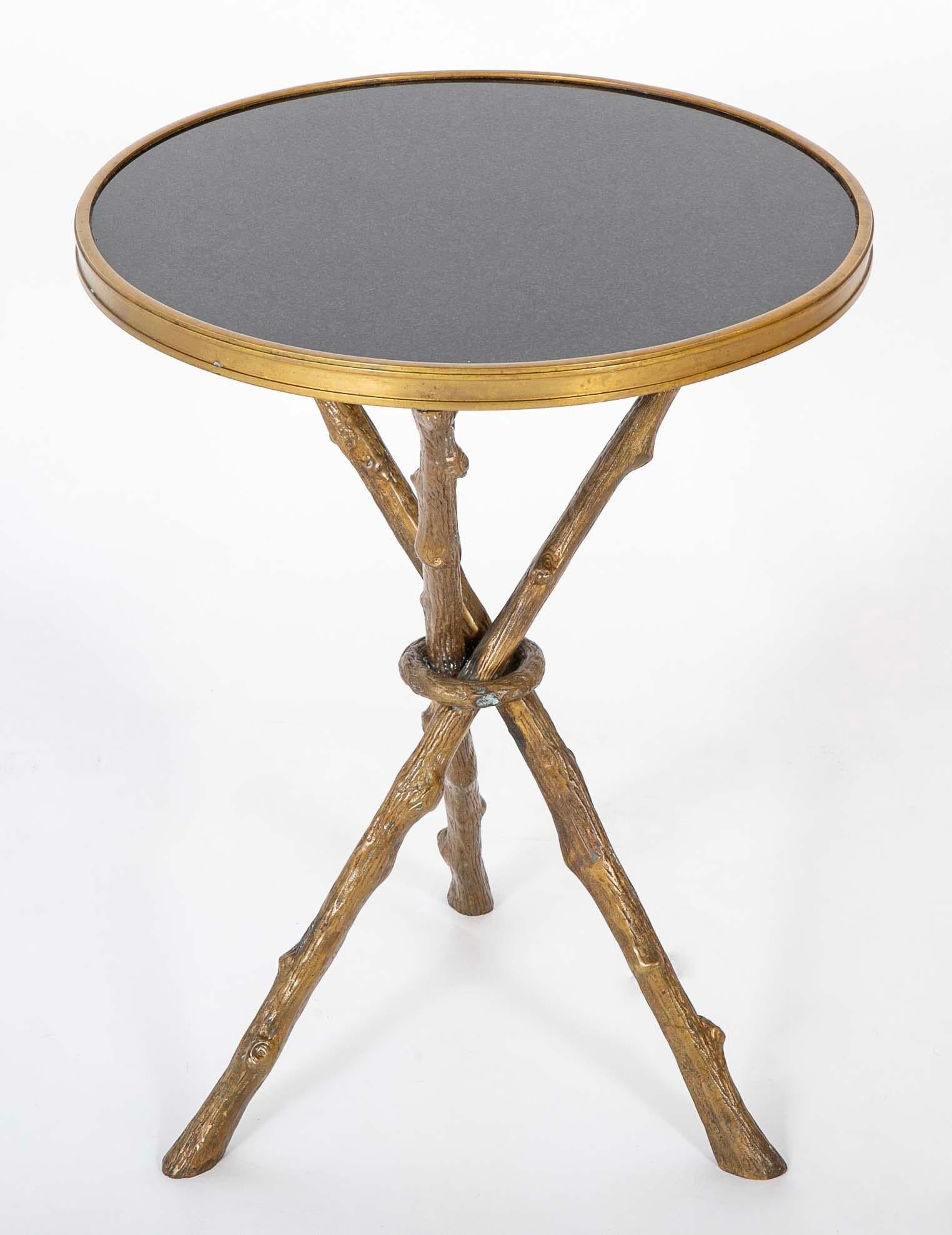 Regency style side table with round polished black granite top over bronze tripod 'faux bois' legs made to resemble tree branches. A very handsome and elegant side or drinks table suitable for both modern and traditional rooms. Beautifully made and
