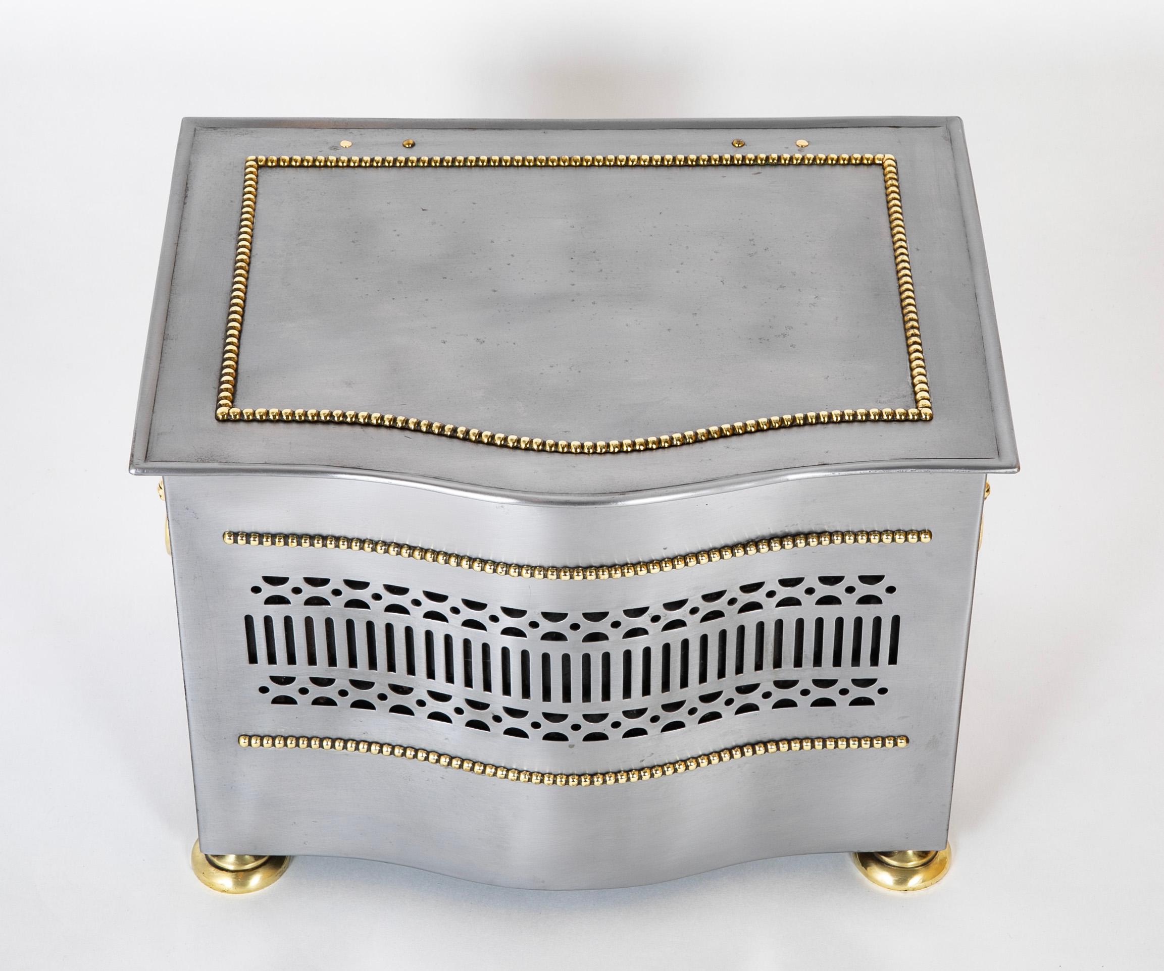 Unusual and very handsome brushed steel and polished brass tinder box. This box has a removable tin liner that would have been used to fill with hot coals and used as a portable heater. When not is use it was for storing kindling by the fireplace.