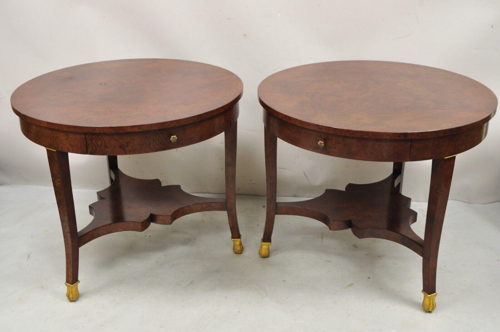 Regency style burl wood paw feet tripod round side tables with drawer - a pair. Item features a lower shelf, gold gilt carved paw feet, beautiful wood grain, original label, 1 drawer. Circa late 20th century. Measurements: 25.5