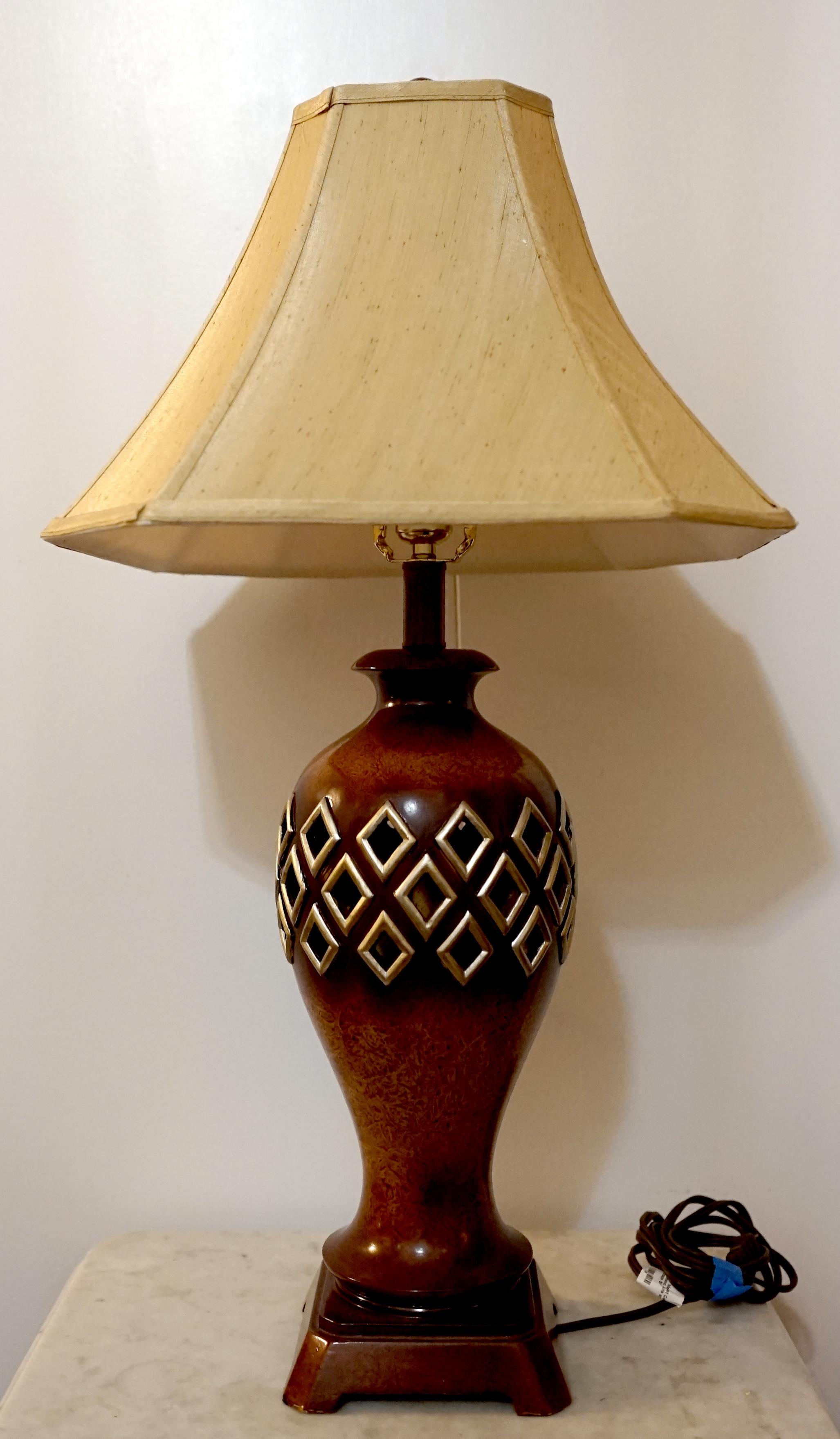 This lamp is a vintage Regency style pierced burled wood, baluster table lamp
from the second half 20th Century. Beautiful wood grain and patina. The most memorable feature is the diamond cut-outs, which are enhanced with faux-gilt highlights. The