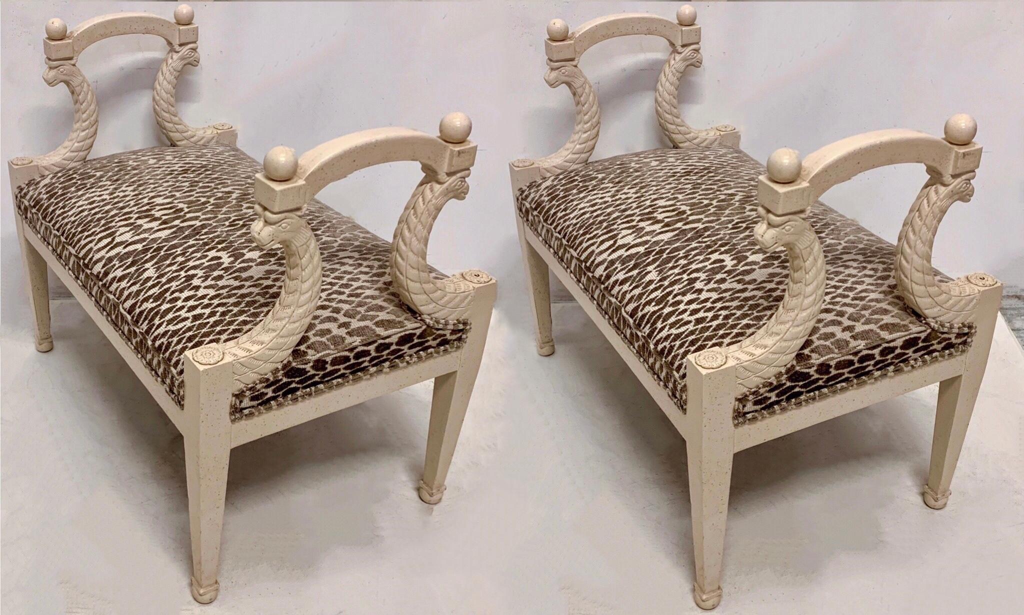 This is a good looking pair Regency style carved and painted benches by Baker Furniture. The neutral leopard upholstery is in excellent condition. The ivory frame is intentionally distressed. Note the Dual serpents supporting each arm!