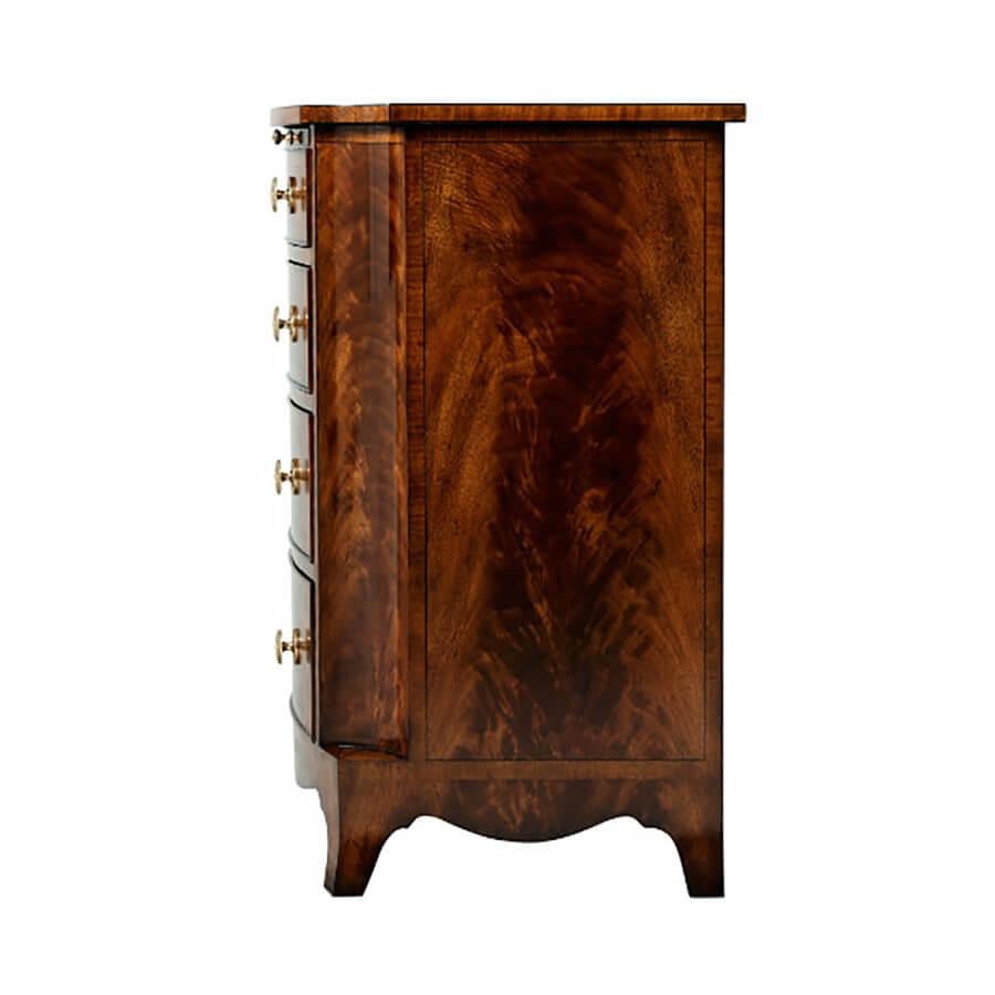 A fine flame mahogany chest of drawers, the bow front satinwood crossbanded top with concave corners and uprights, above a veneered slide and four graduated bow front drawers, with natural brass handles, on splay legs. Inspired a Regency