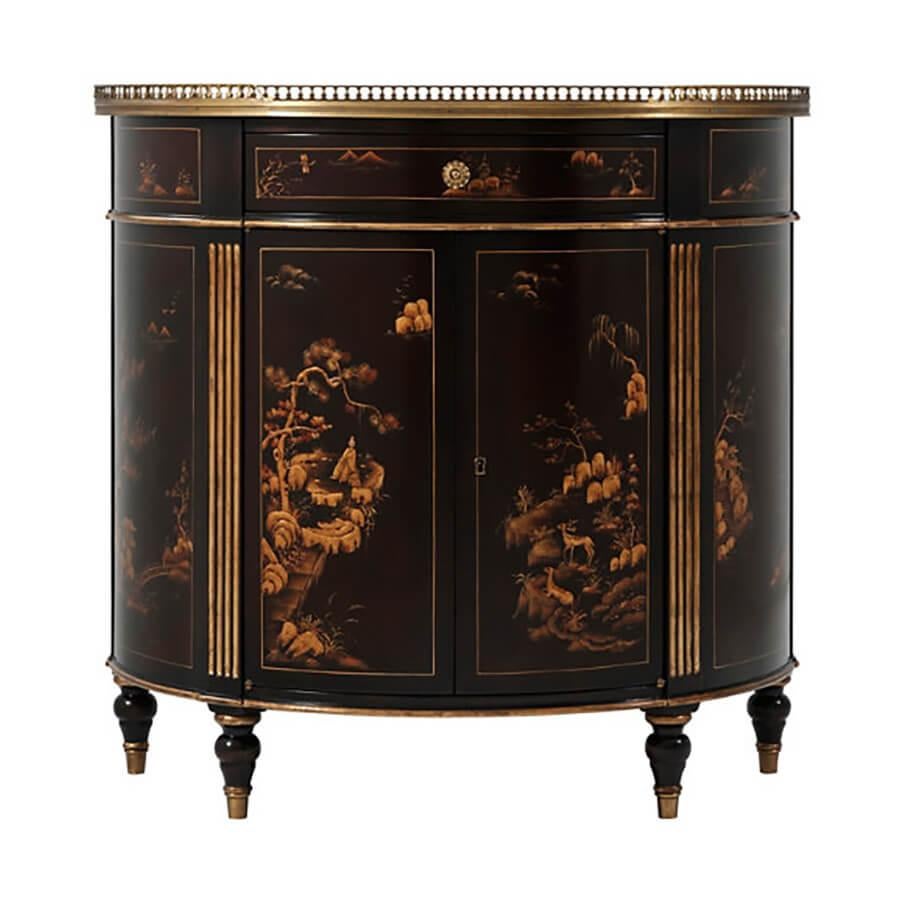 An English Regency style chinoiserie cabinet with a bow front and hand-painted chocolate brown, the three-quarter pierced brass galleried top above a frieze drawer and two cabinet doors between gold fluted uprights enclosing an adjustable shelf, on