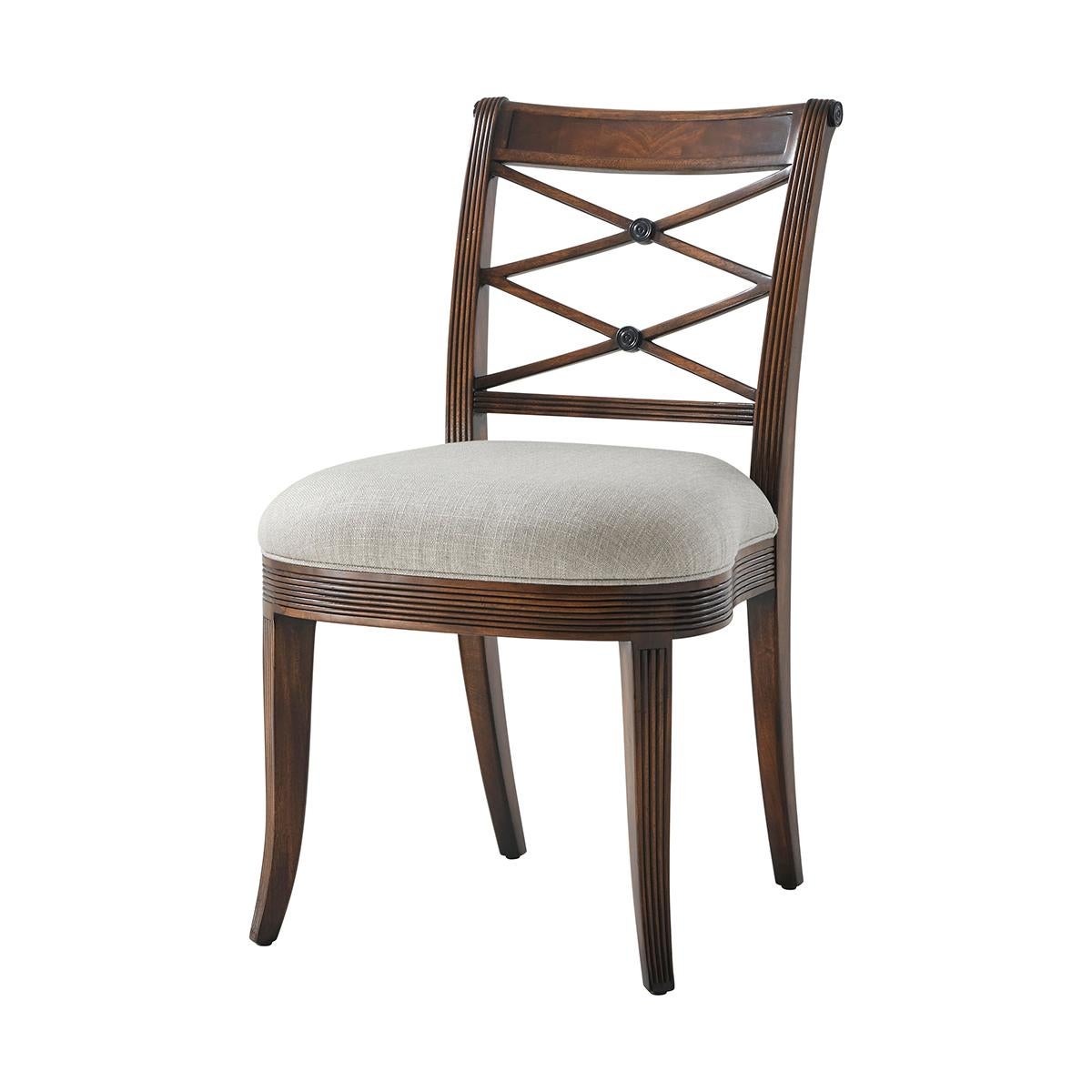 Hand carved side chair with reeded decoration, the over scroll and double ‘X’ pierced back above an upholstered seat, on sabre legs.
Dimensions: 20
