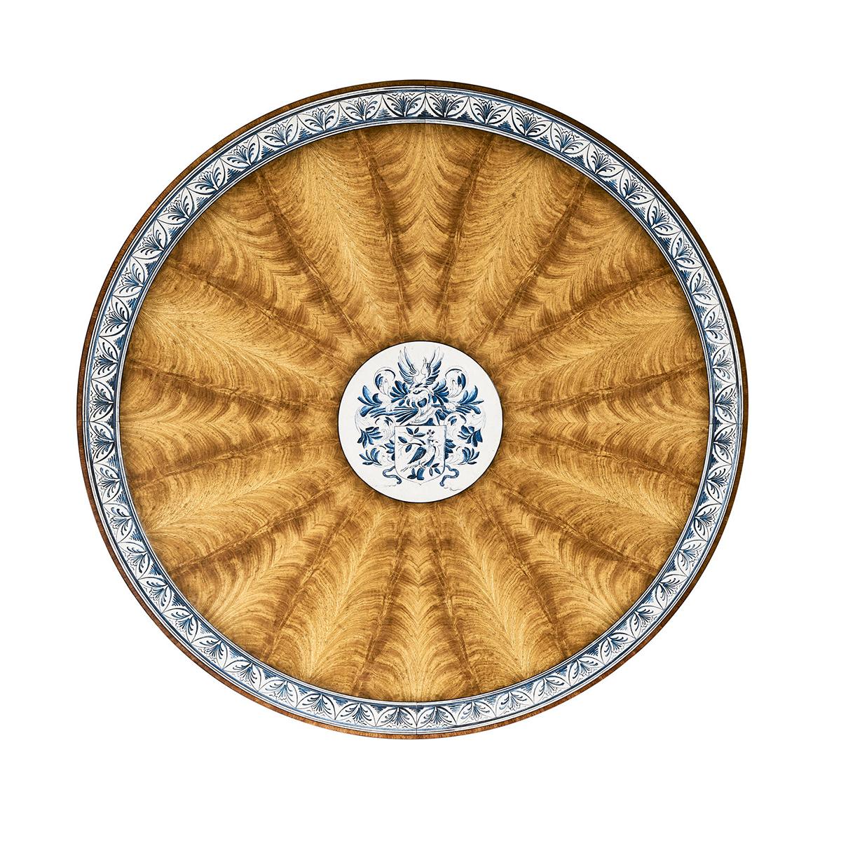58-inch diameter with seating for up to six. A classic early 19th-century English design with handpainted crossbanding in a Dutch Delft pattern.

The round, fixed tabletop showcases the artistry of inlaid veneer work, capturing the eye with its