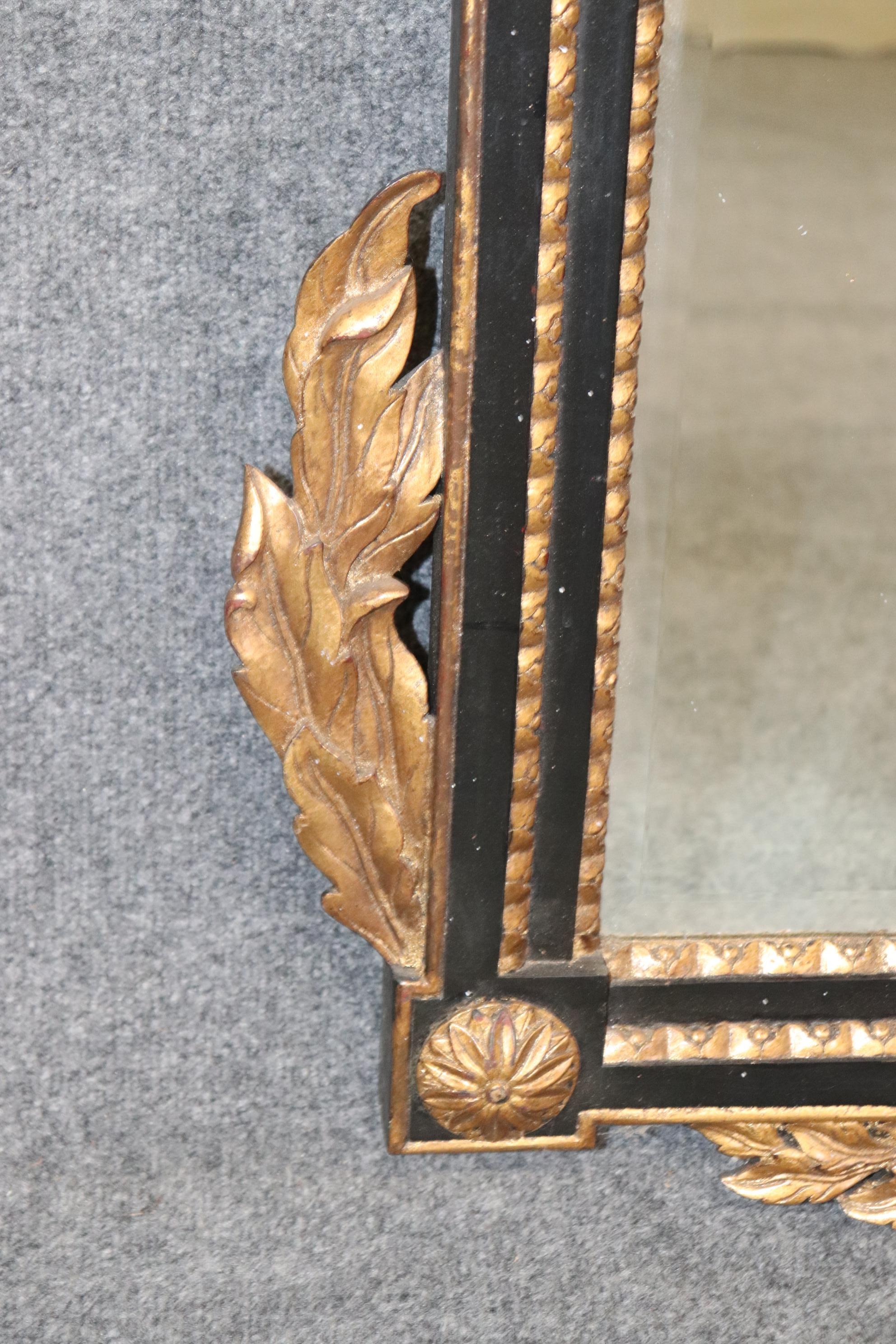 20th Century Regency Style Ebonized and Gilt Carved Floral Wall Hanging Mirror For Sale