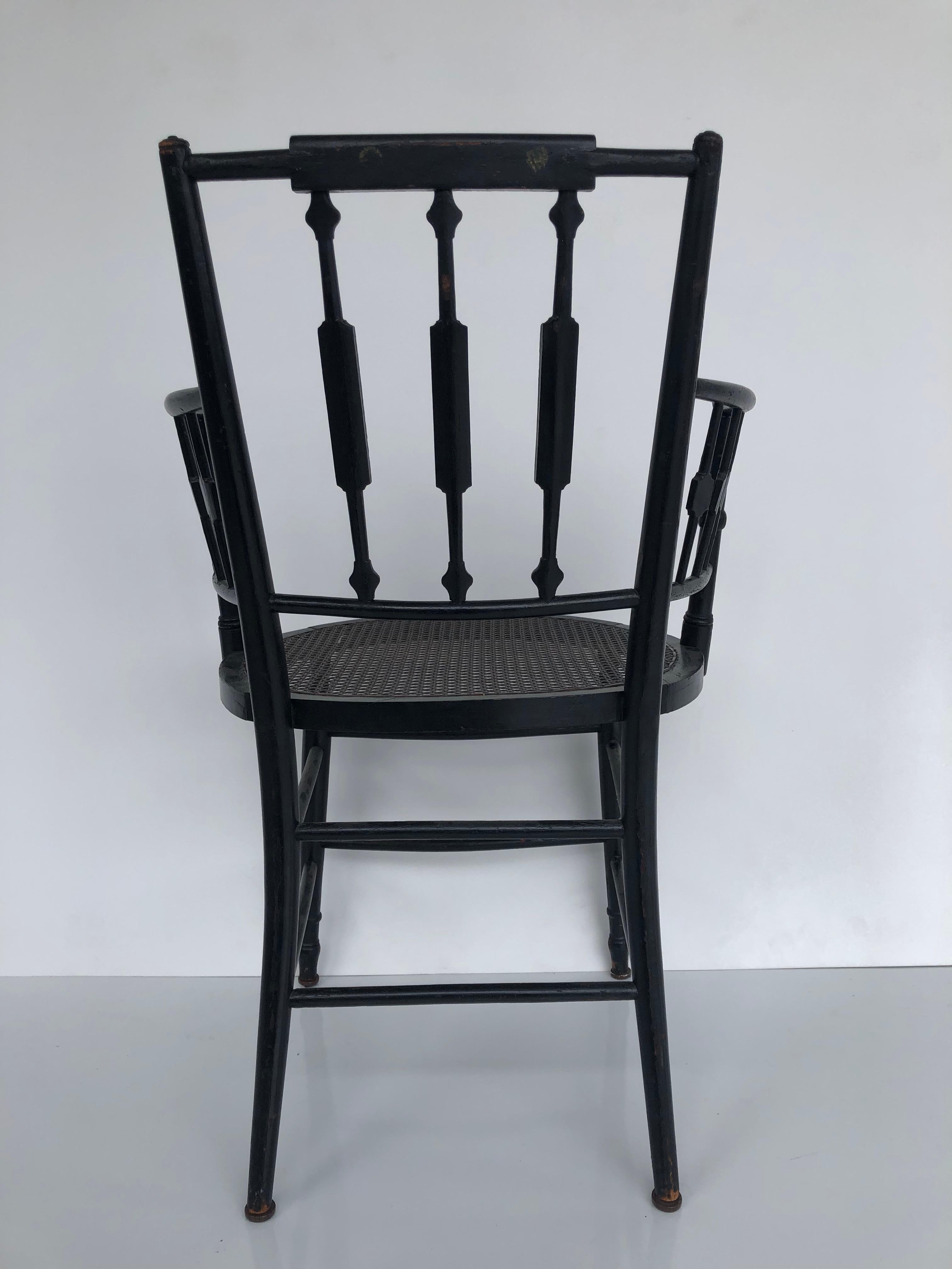 Paire de fauteuils à dossier fléchi et à assise cannée de style Regency, en bois d'ébène 9