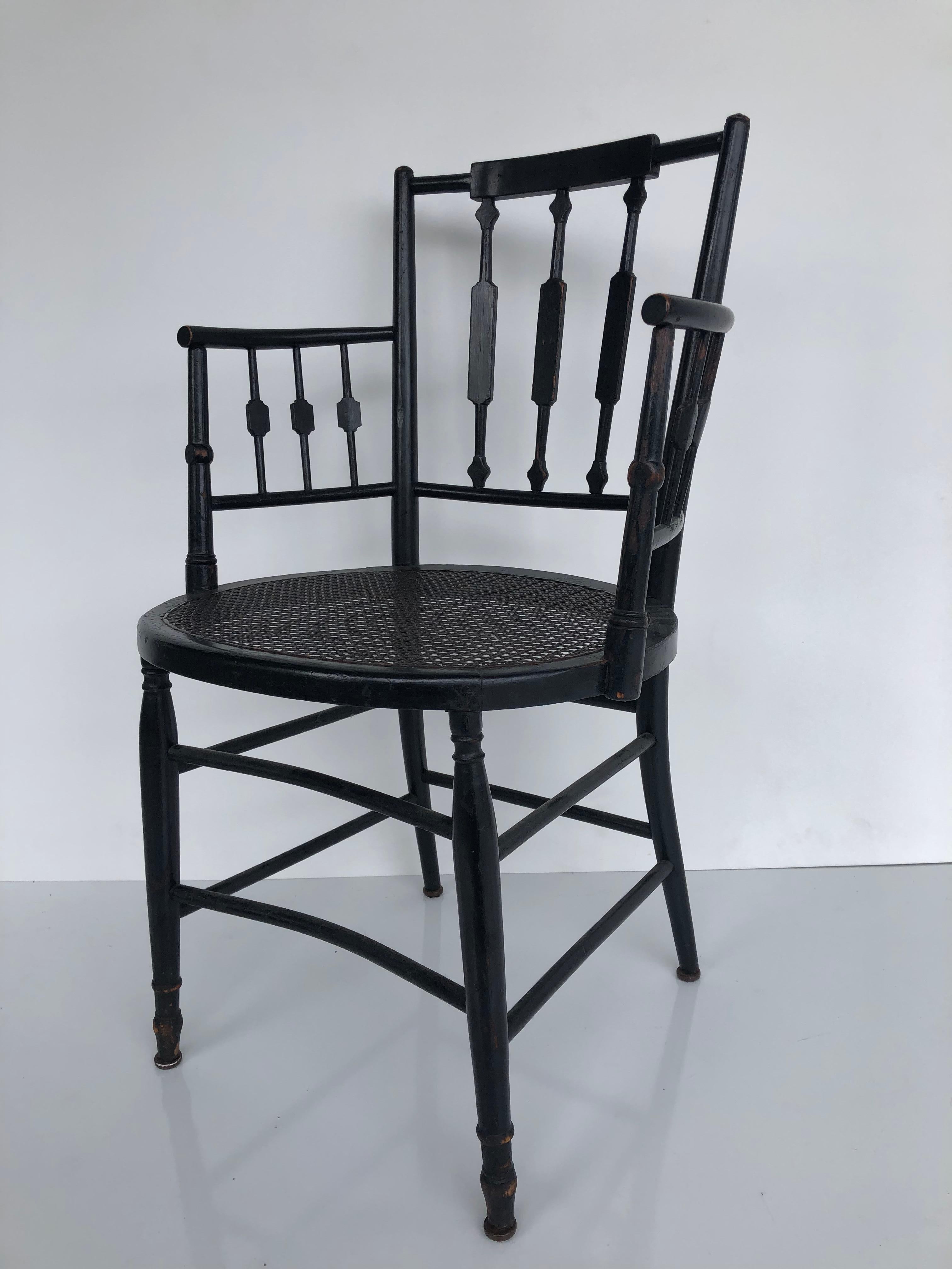 20ième siècle Paire de fauteuils à dossier fléchi et à assise cannée de style Regency, en bois d'ébène