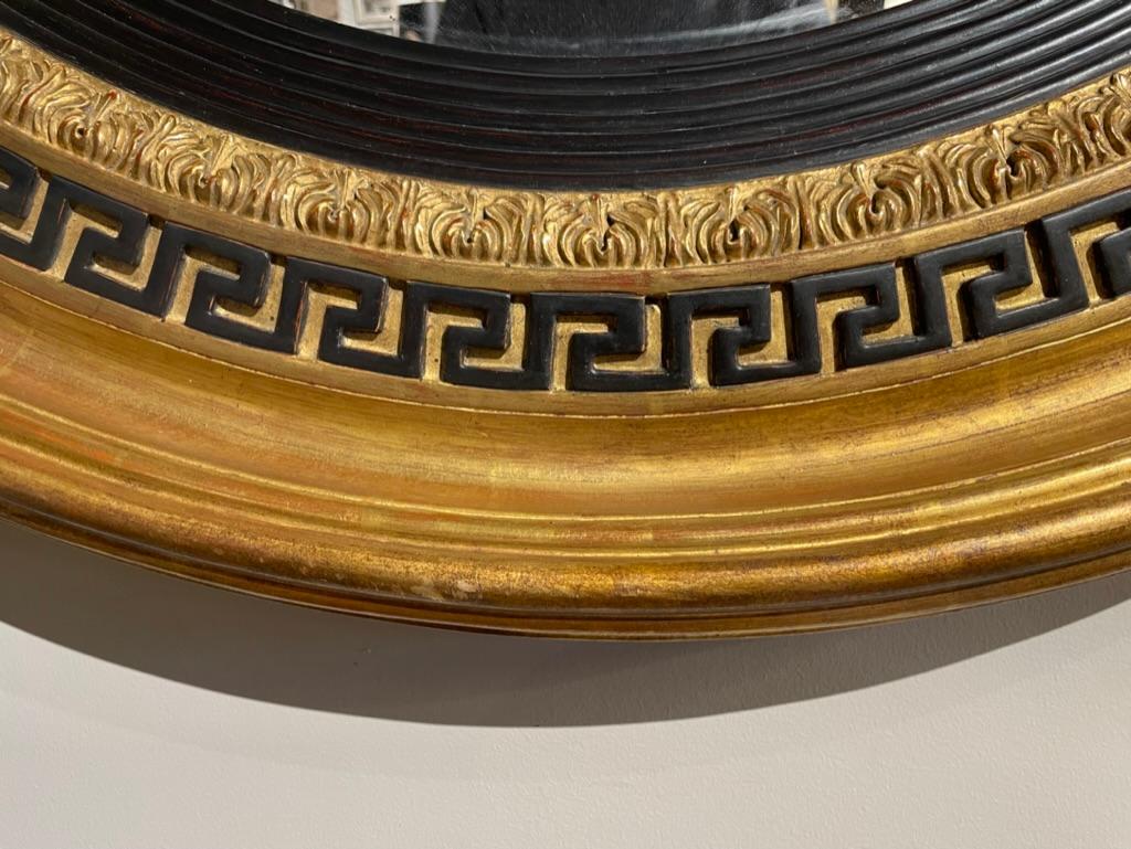 Carved Regency Style Ebonized Gilt Wood Convex Mirror with Greek Key Molding