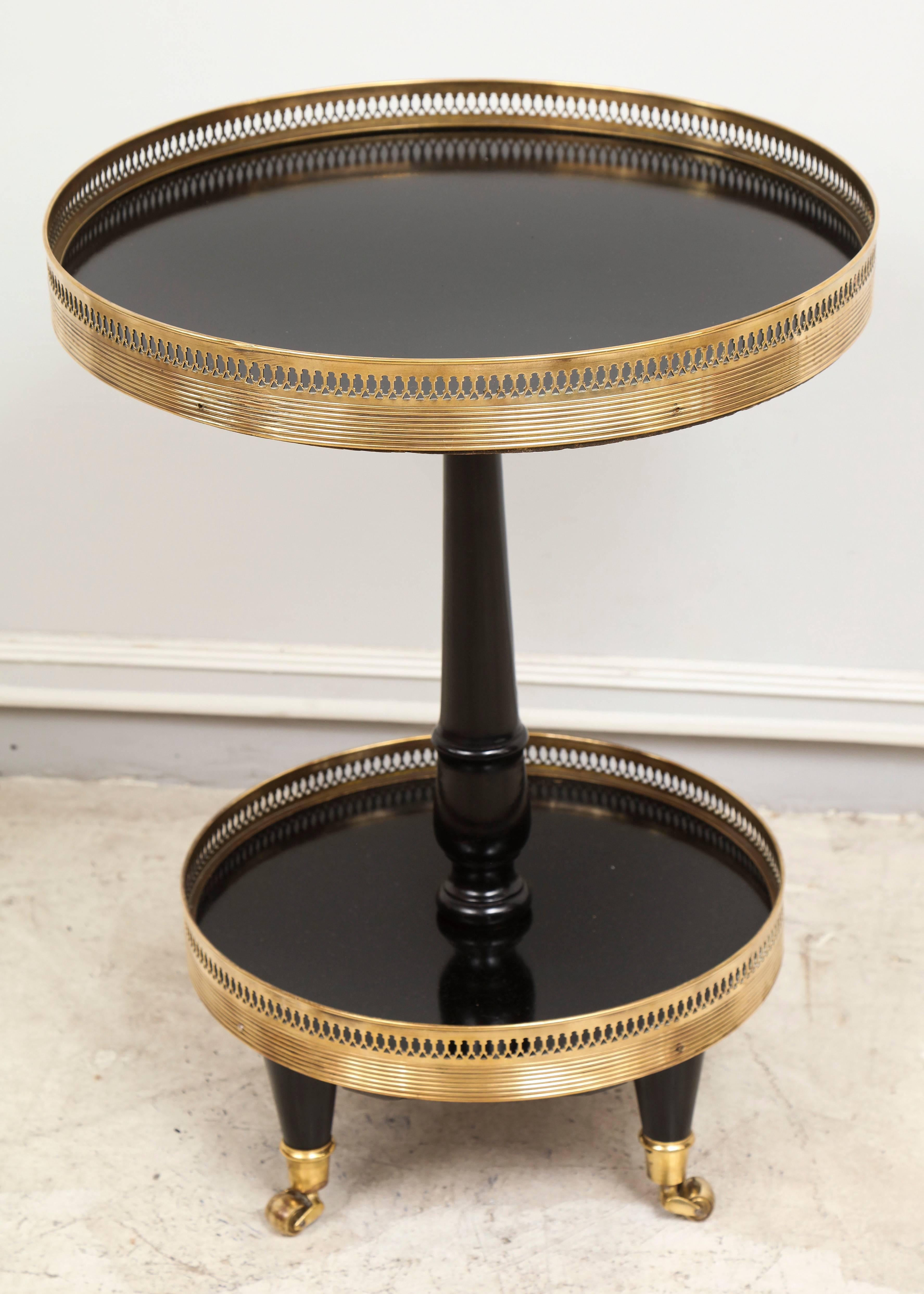 Regency style end table with brass gallery on brass sabots.