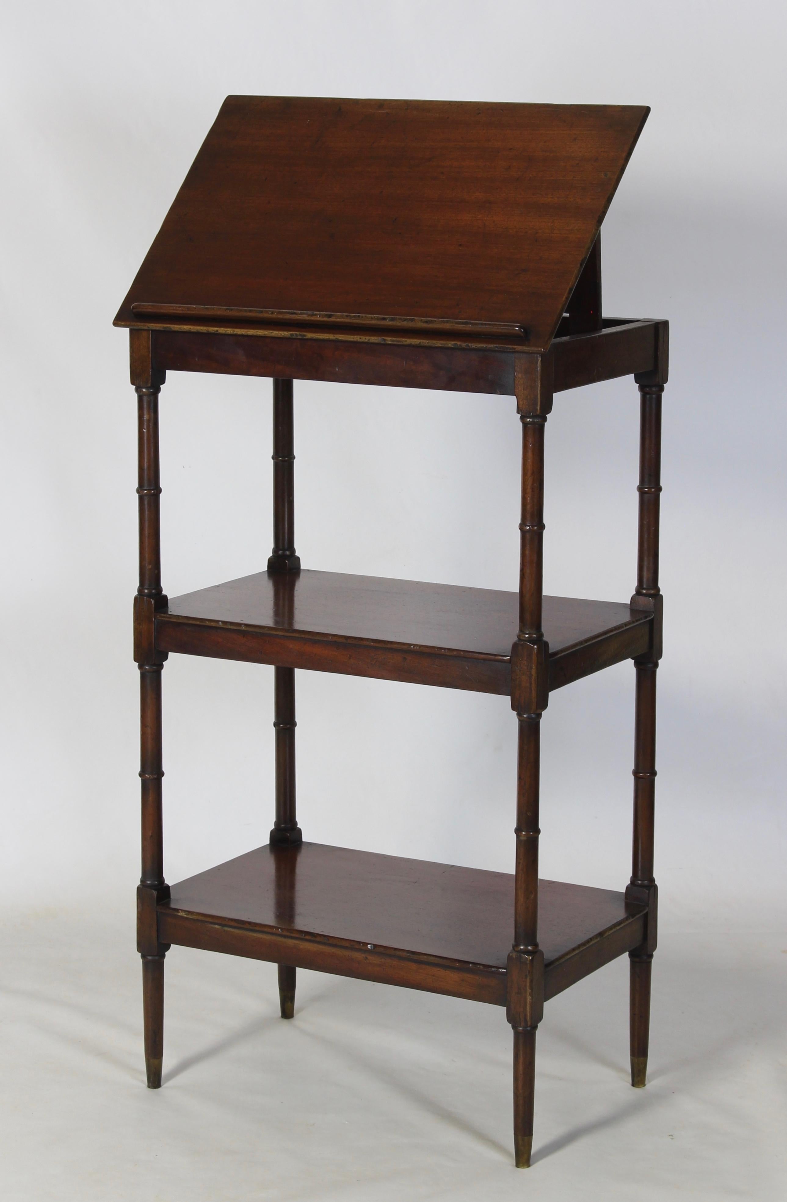 A late 19th century mahogany Regency style two-shelf étagère bookstand with adjustable top resting on faux bamboo legs terminating in brass caps.