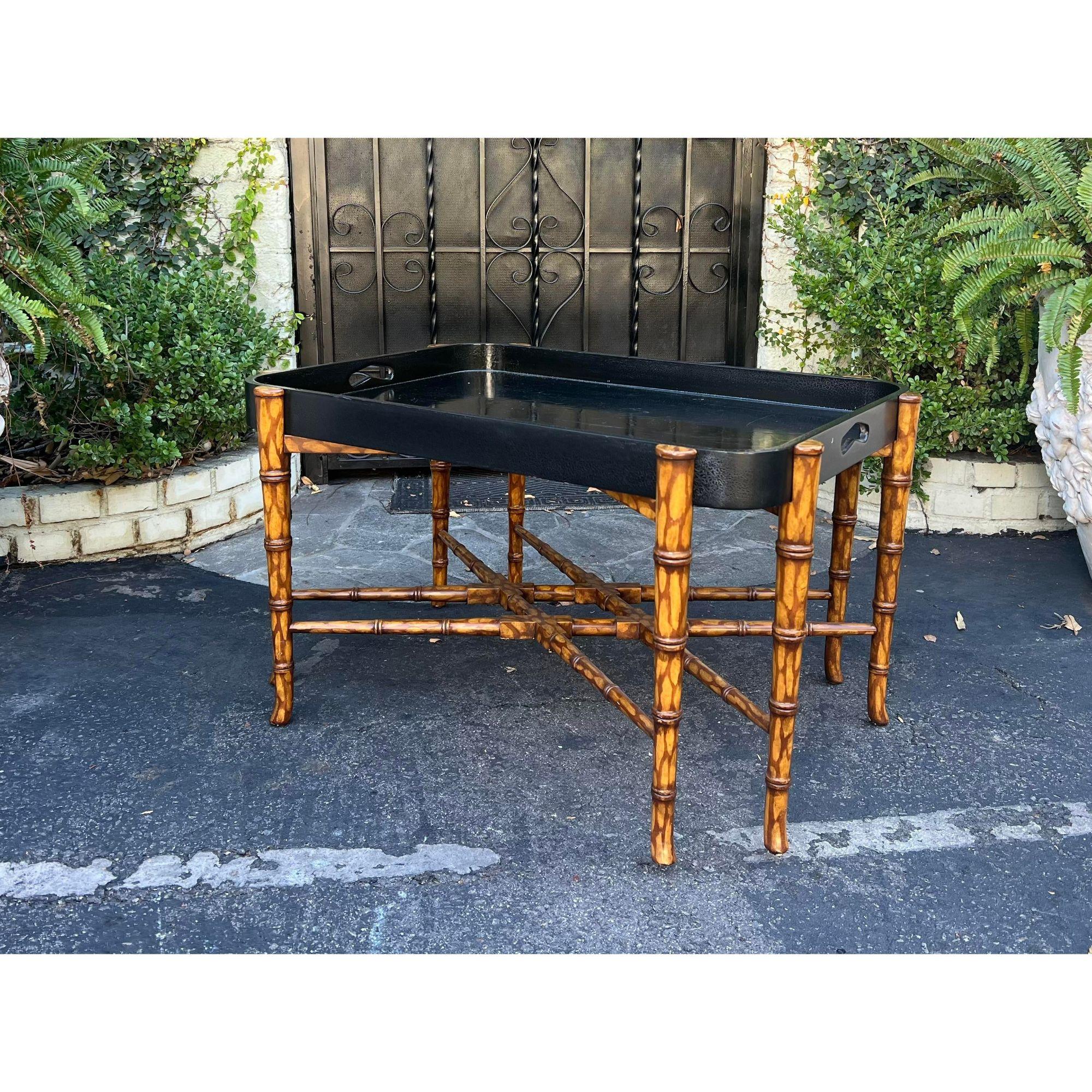 Dessin Fournir Regency Style Faux Bamboo & Black Lacquer Coffee Table. It features a removable black crackle lacquer tray that sits on a faux bamboo stand.