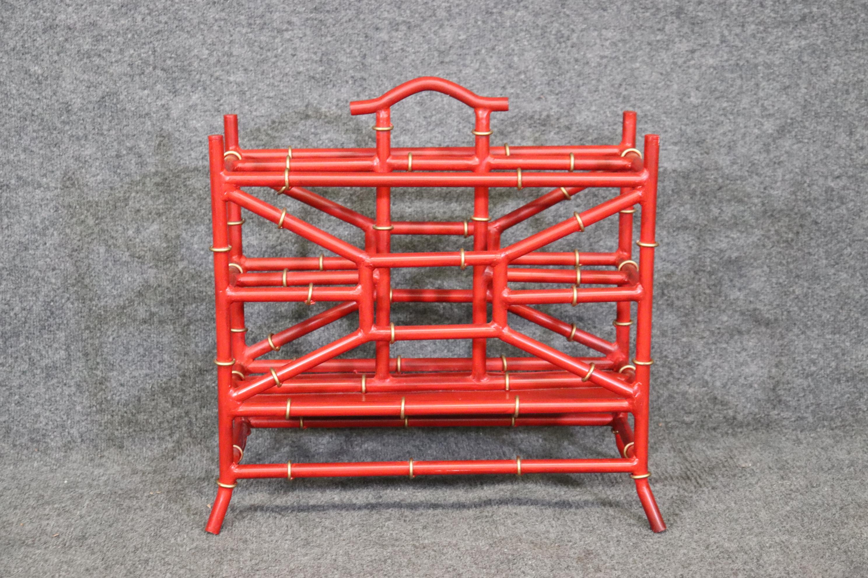 Dimensions- H: 19 3/4in W: 20 1/2in D: 8 1/2in 

This metal faux bamboo red magazine rack in the manner of Maison Bagues, is truly a unique and quality piece! This piece is bound to bring a sense of Minimalistic luxury and modernism into your living