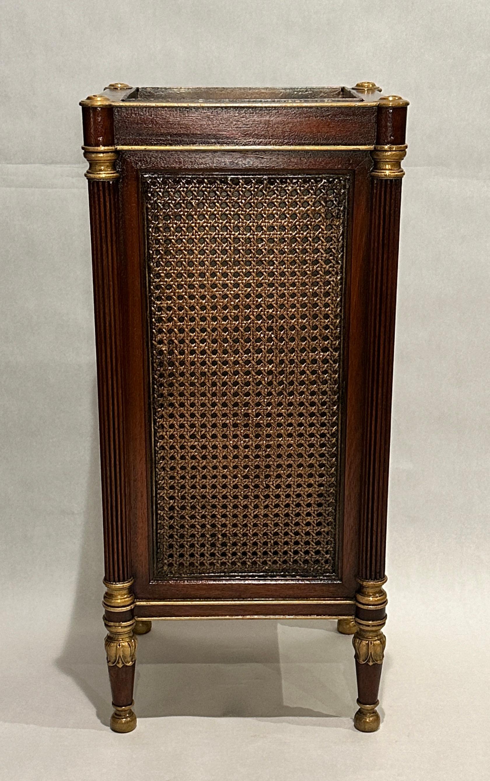 Carved and gilt mahogany umbrella/stick stand with cane panels. Fluted column corners with carved acanthus leaf tapered legs.
8