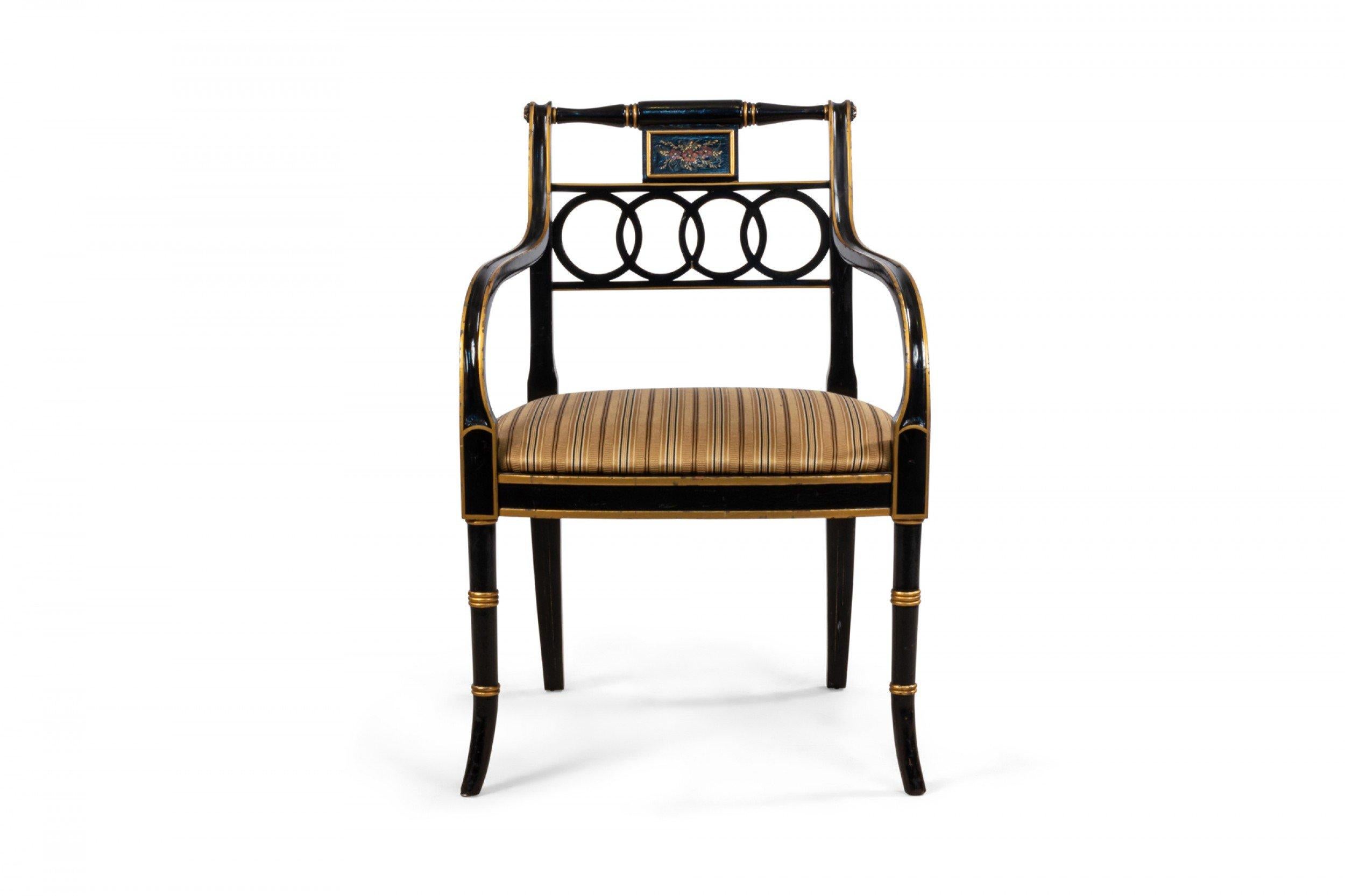 Pair of English Regency style black lacquer and gilt armchairs with pierced backs having concentric circle design and painted floral center panel with gold satin upholstery supported on faux bamboo splayed legs.
