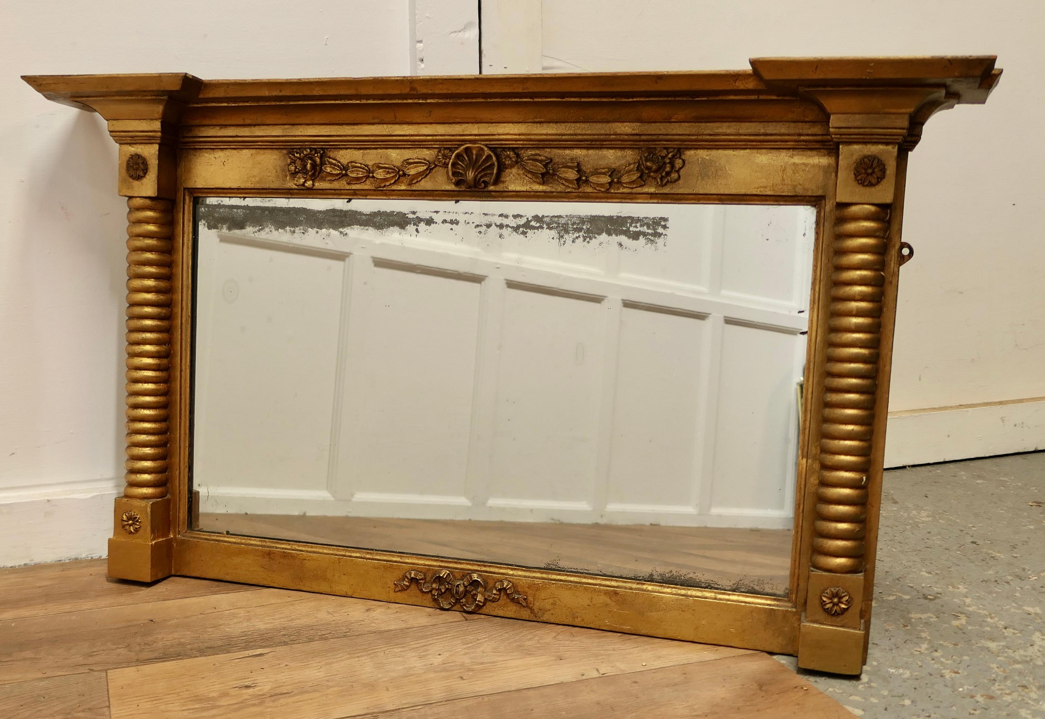 Regency Style Gilt Mirror or Over Mantle 

The Regency style carved Frame is a rectangular shape, it has twisted columns at either side and a shell and leaf design along the top.
The mirror has an old mercury rectangular glass, the glass is original