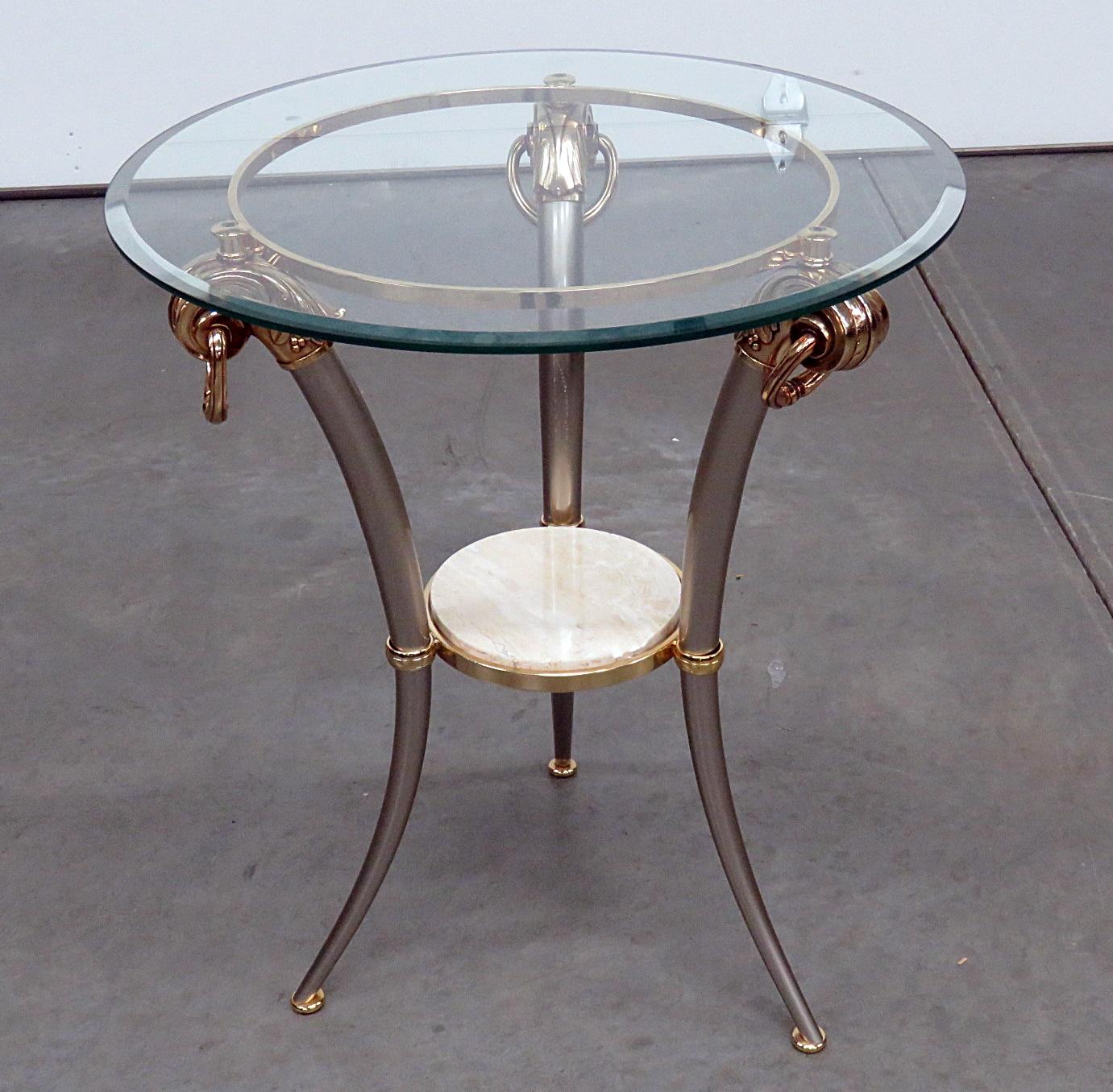 Regency style glass top side table with beveled glass on top, a marble insert on the bottom, and brass accents.
