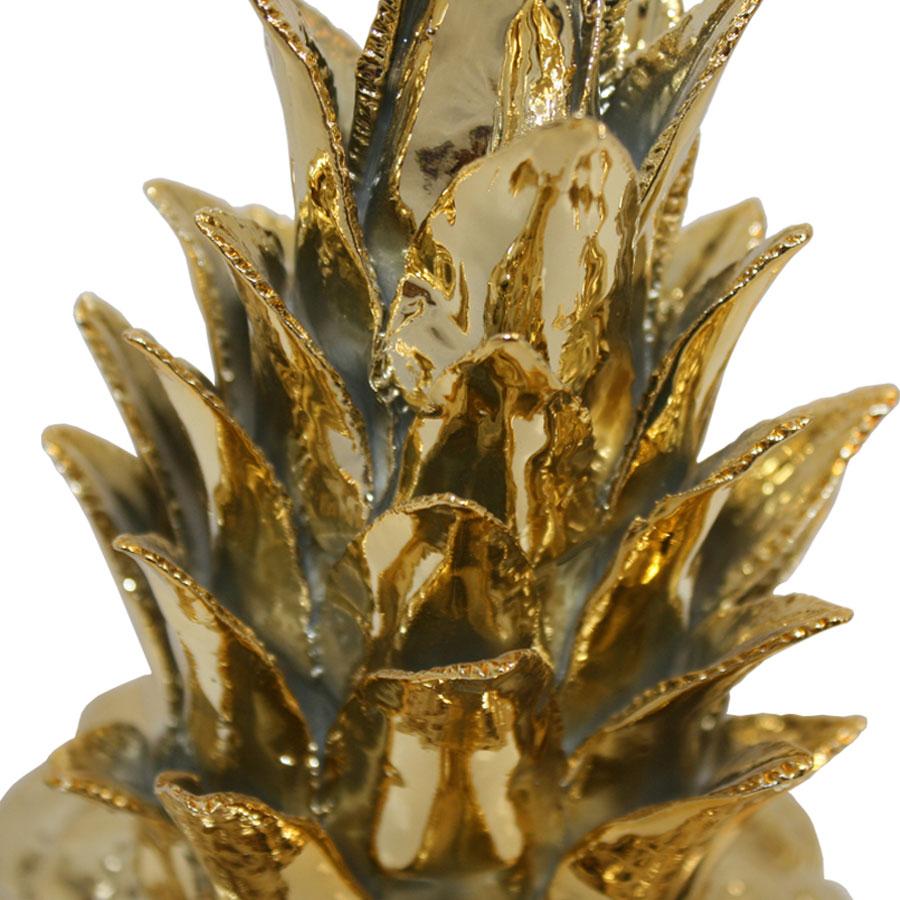 Decorative pineapple made of porcelain and covered with high gloss gold enamel.