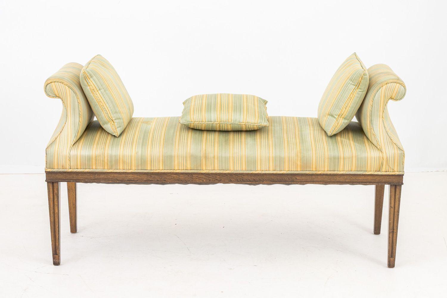 Regency Style Grain Painted Window Seat, having curved arms with green and yellow striped upholstered seat and three cushions on four tapered legs. 30.5