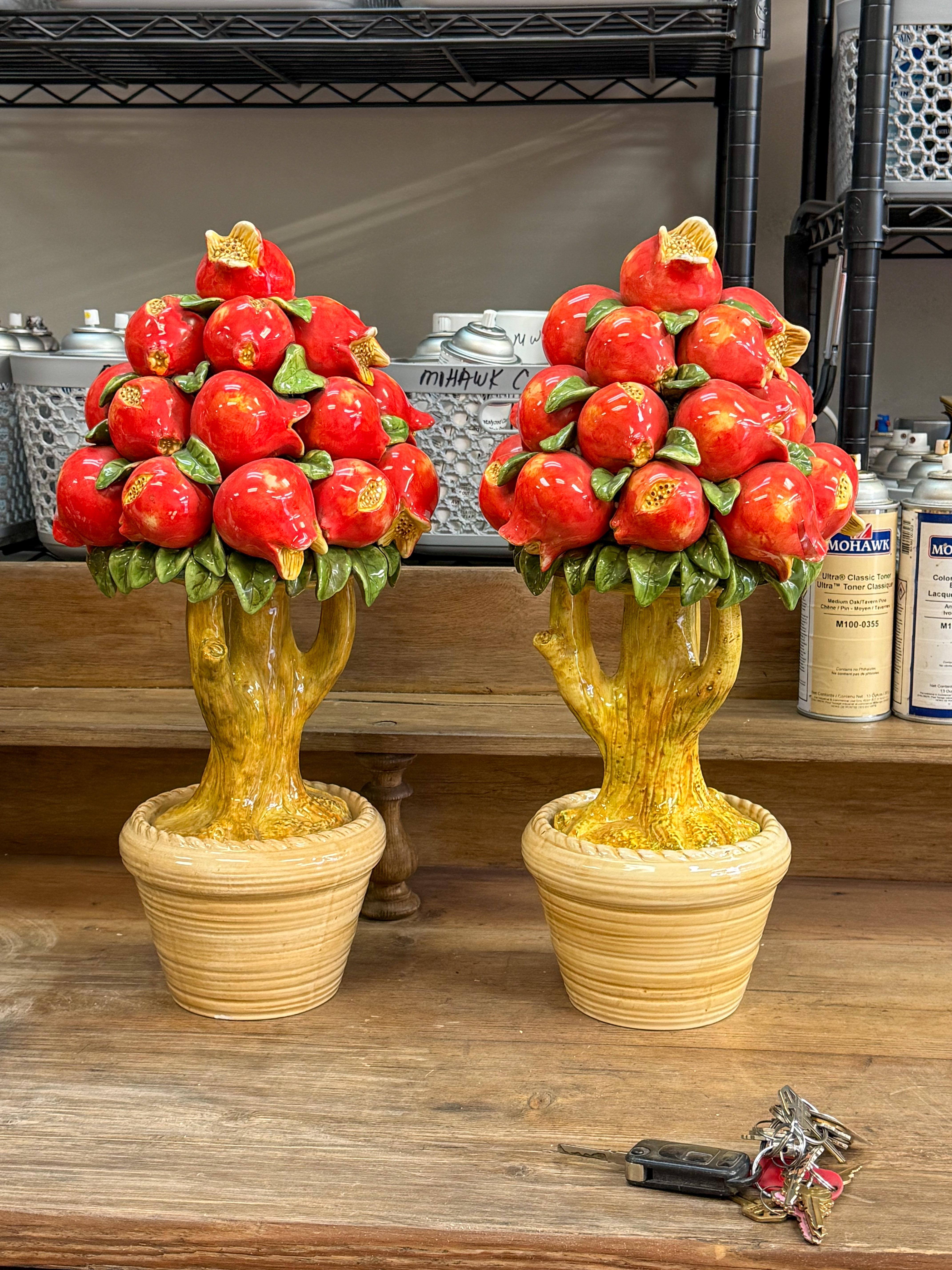This is a pretty set of hand painted pomegranate fruit topiaries. They are ceramic and purported to be Italian. They are unmarked and in very good condition. 