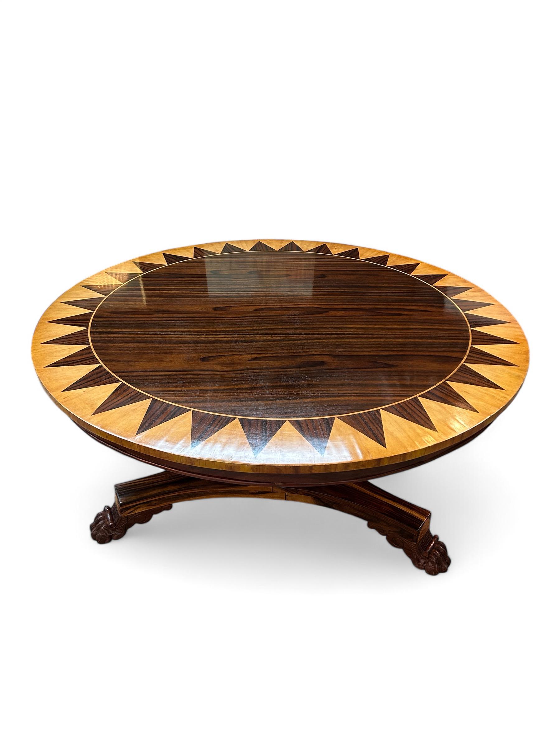 Elevate your living space with this exquisite Italian Regency style center table, a true masterpiece of craftsmanship and design. Featuring a striking top inlaid with rich rosewood and pine veneers in a captivating starburst pattern, this table is