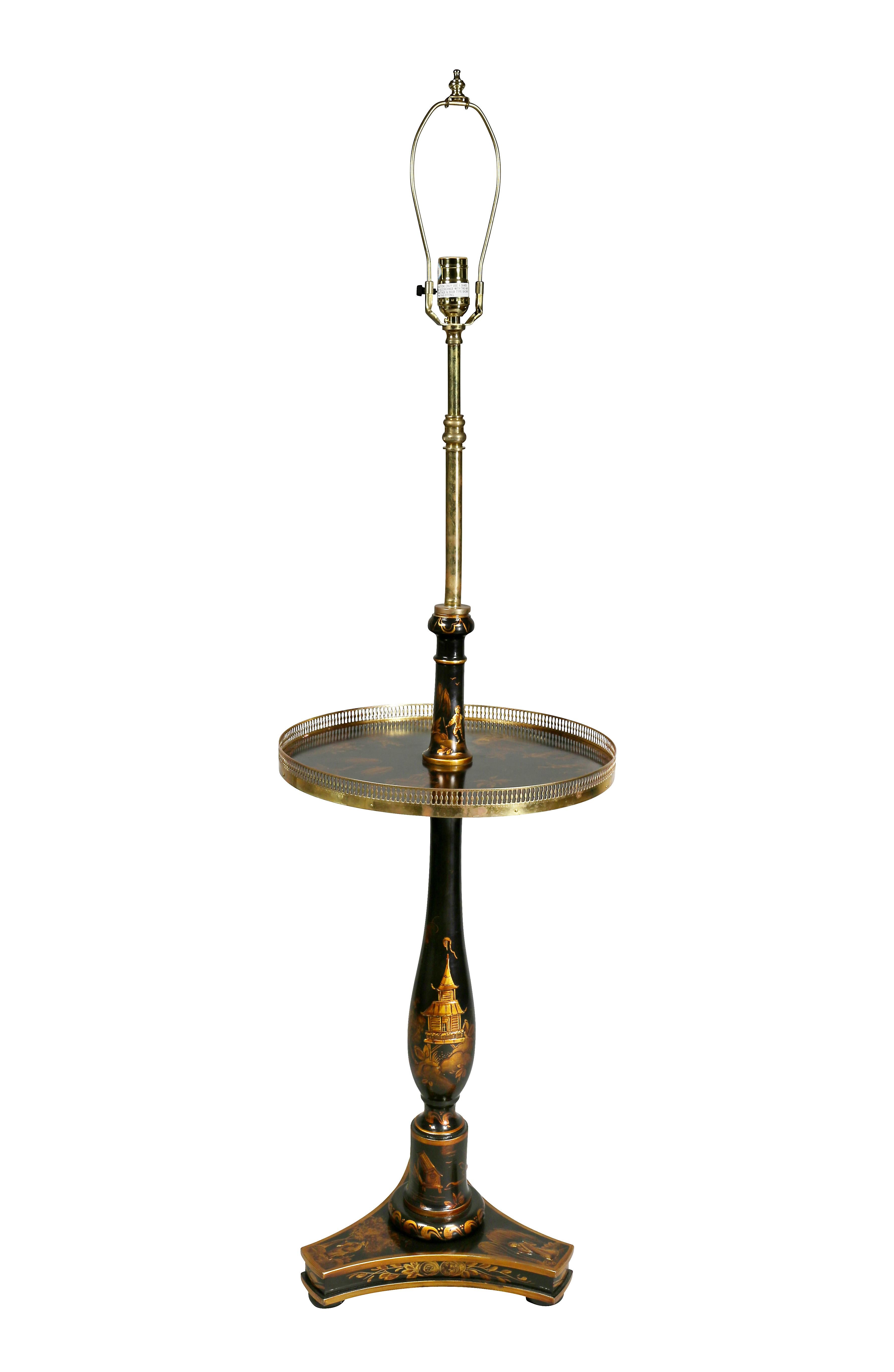 With brass fittings, one light and lower circular shelf with brass gallery raised on a tripartite base. Estate of Michael D. Dingman.