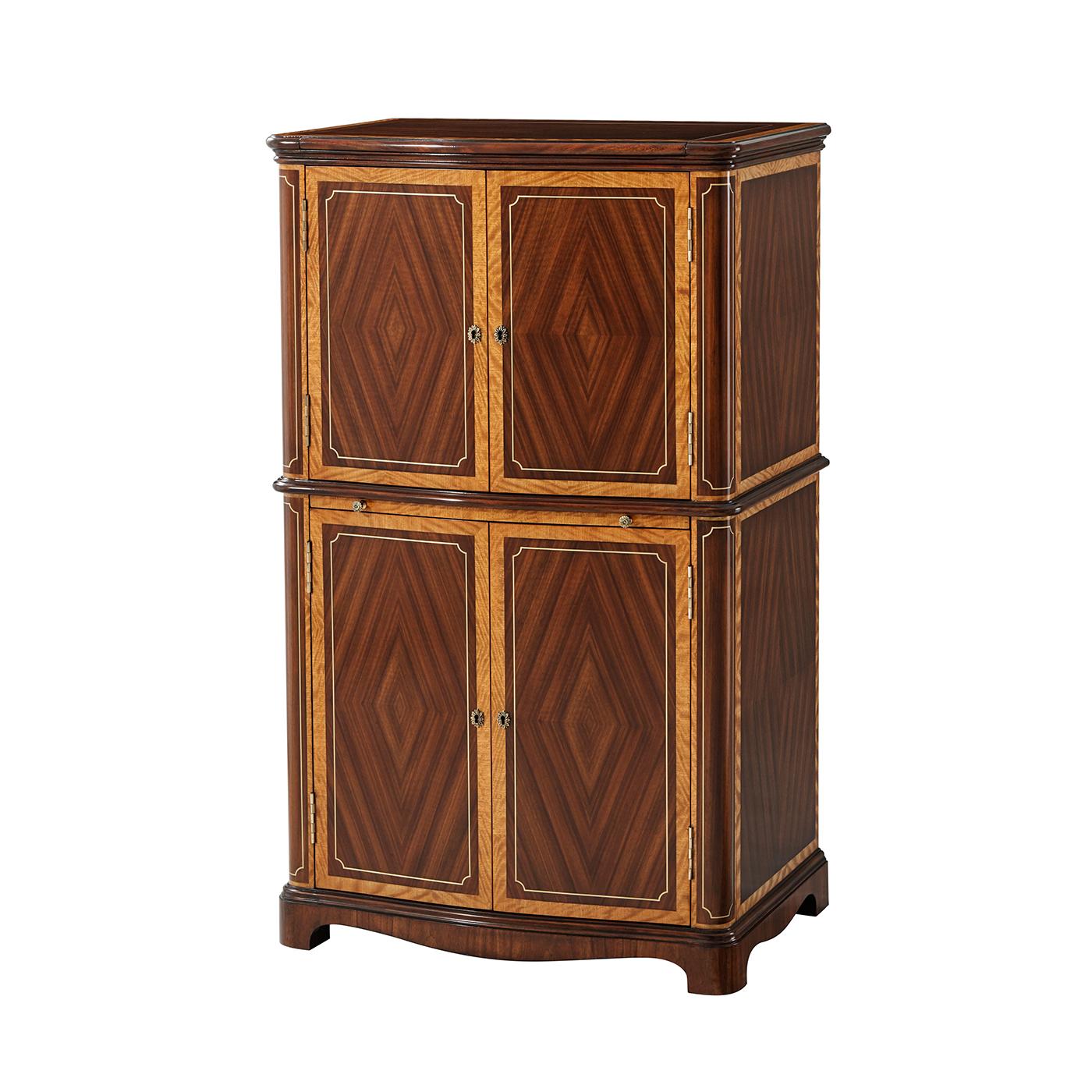 A Regency style solid mahogany and figured Etimoe veneer crossbanded jewelry cabinet. With Old English brass accents, lift-up mirror top, the upper cabinet fitted with five baize lined drawers, the lower cabinet with slide and single drawer with