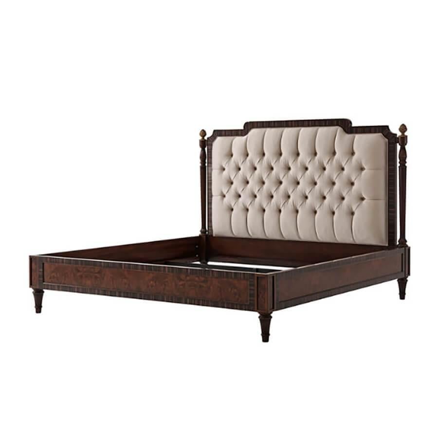 A fine Regency style walnut burl bed with ebonized banding, the shaped and button tufted upholstered headboard flanked by turned and reeded columns with pinecone finials, above paneled rails and tapering turned and reeded legs.

Dimensions: 81