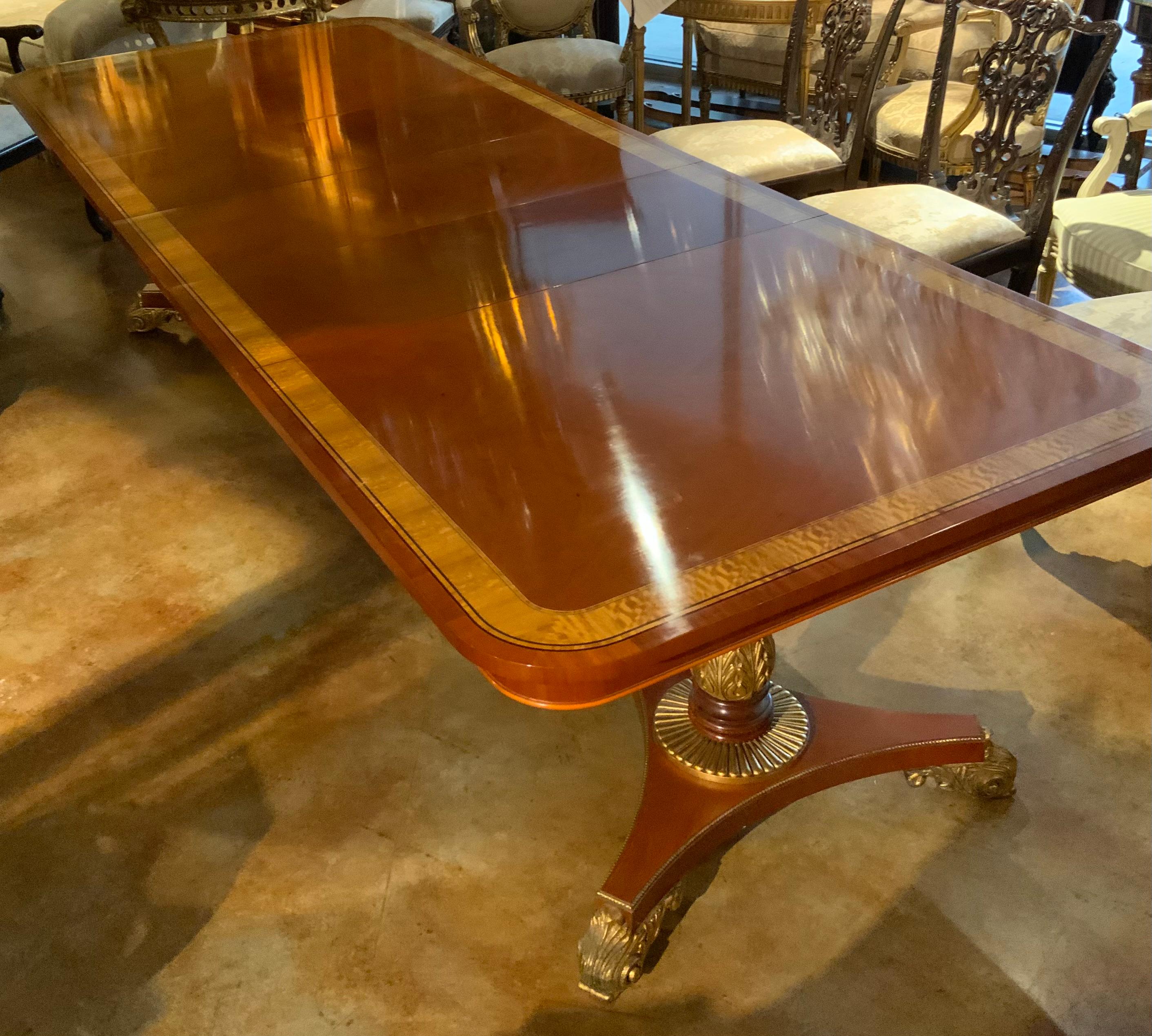 This table is very well made and has three leaves so that it is adaptable 
In size to personal needs. The top is rounded at the ends and has
Banding in satinwood. It is supported with two pedestals , each with a foliate-carved columnar standard with