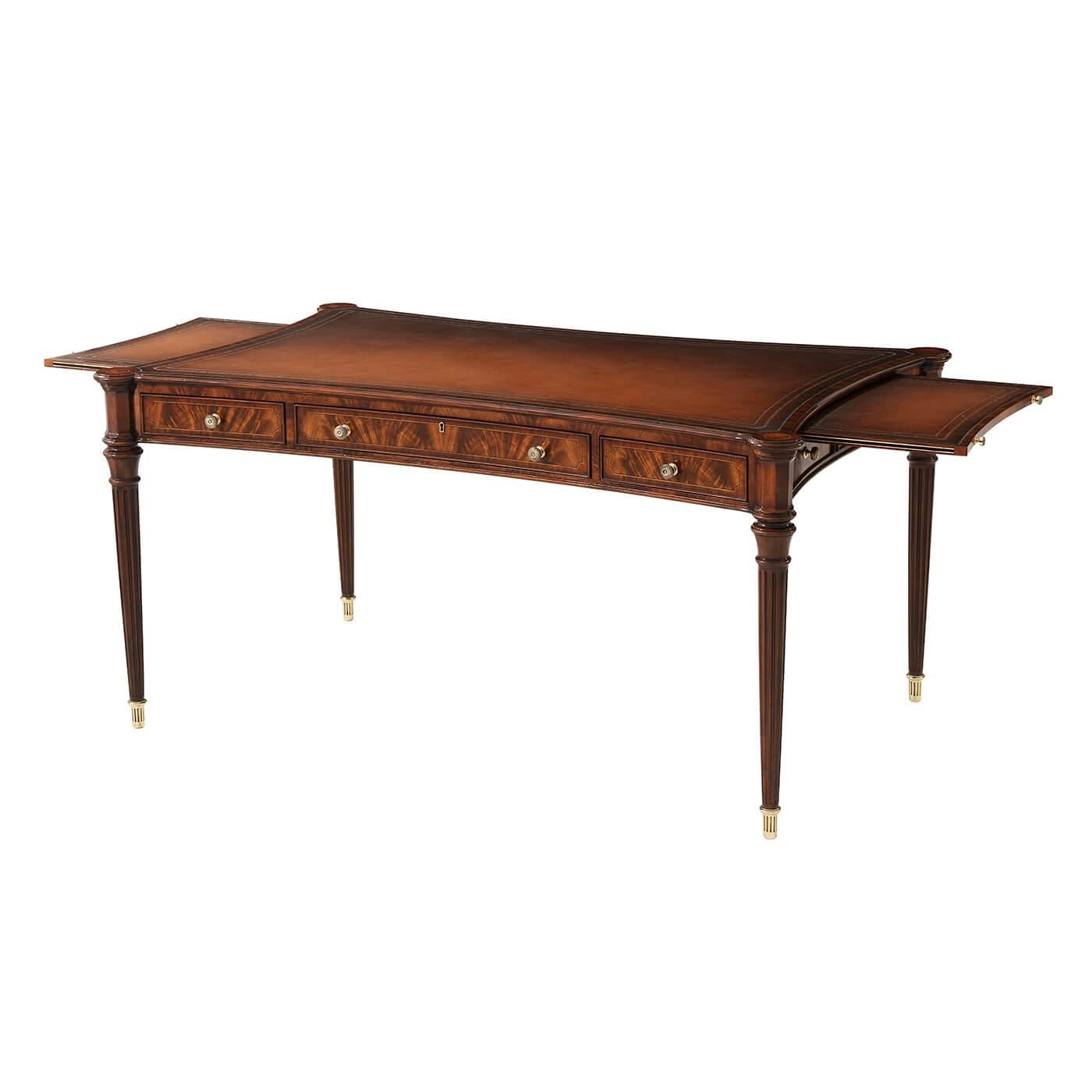 A Regency style finely Morado crossbanded, Sycamore line strung flame veneered and carved mahogany writing table, the concave-sided top with burnished leather and gold-tooled insert to the top and end slides, with Morado crossbanded frieze drawers,