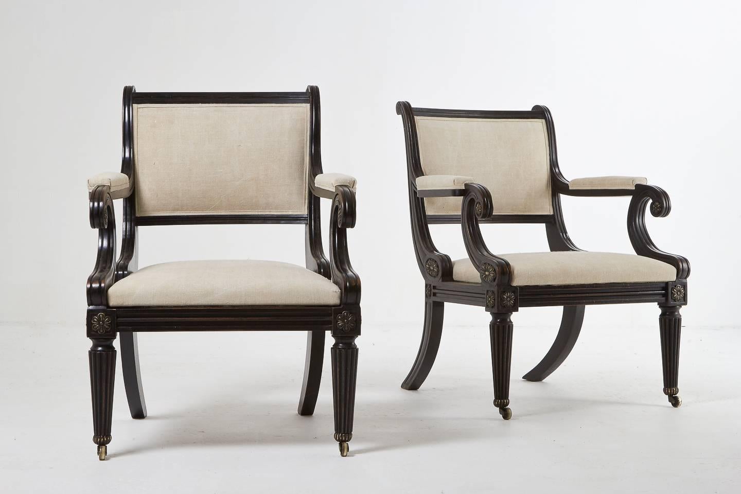 Excellent quality, large 1960s sabre leg Regency style ebonized library armchairs with brass detailing and upholstered in old linen.

Measures: Seat height 43 cm.