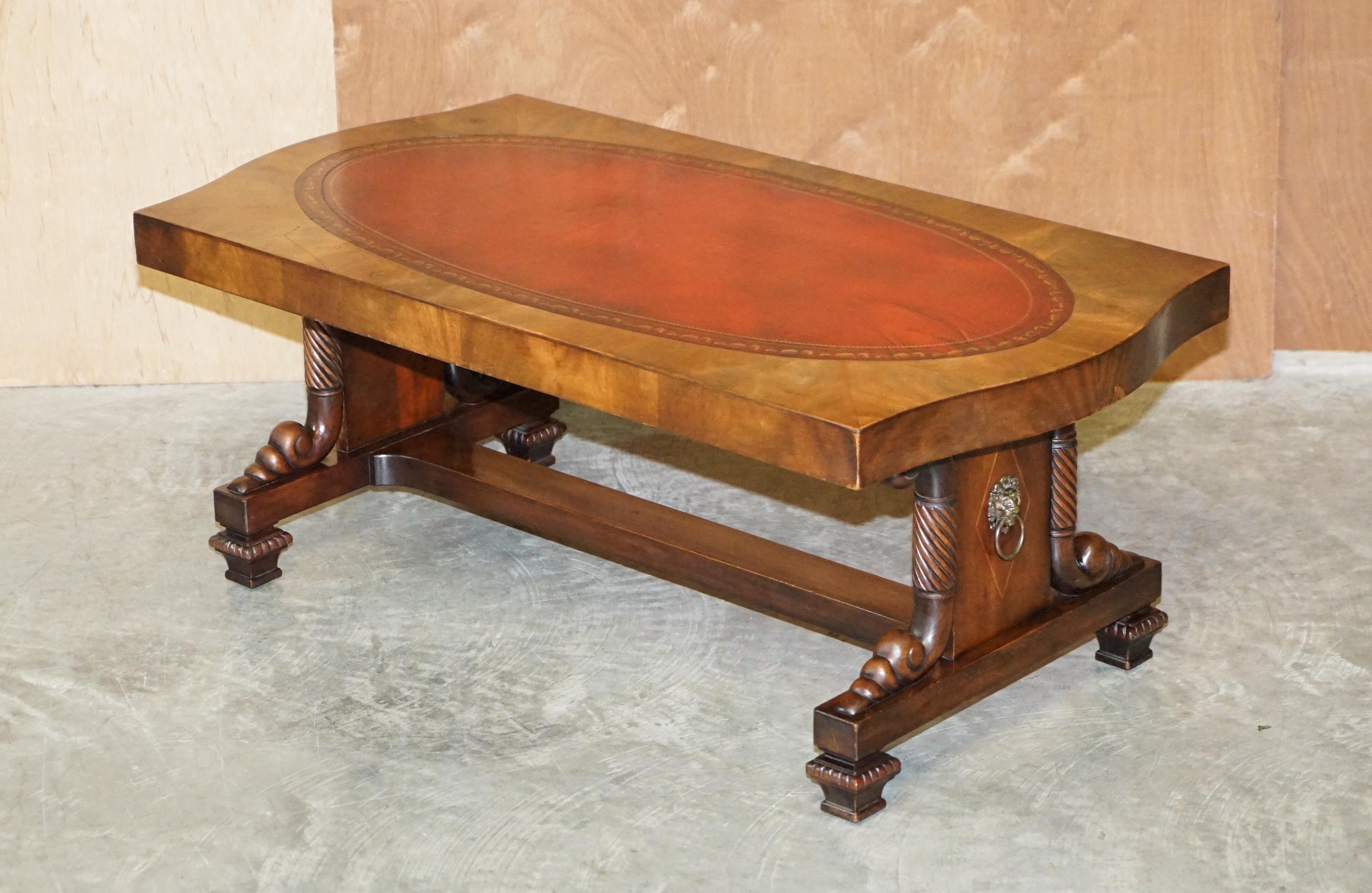 We are delighted to offer for sale this stunning, Regency style coffee table in Walnut with an oxblood oval leather top and Lions Head brass handles

A very good looking well made and decorative coffee or cocktail table. This is based on a Regency