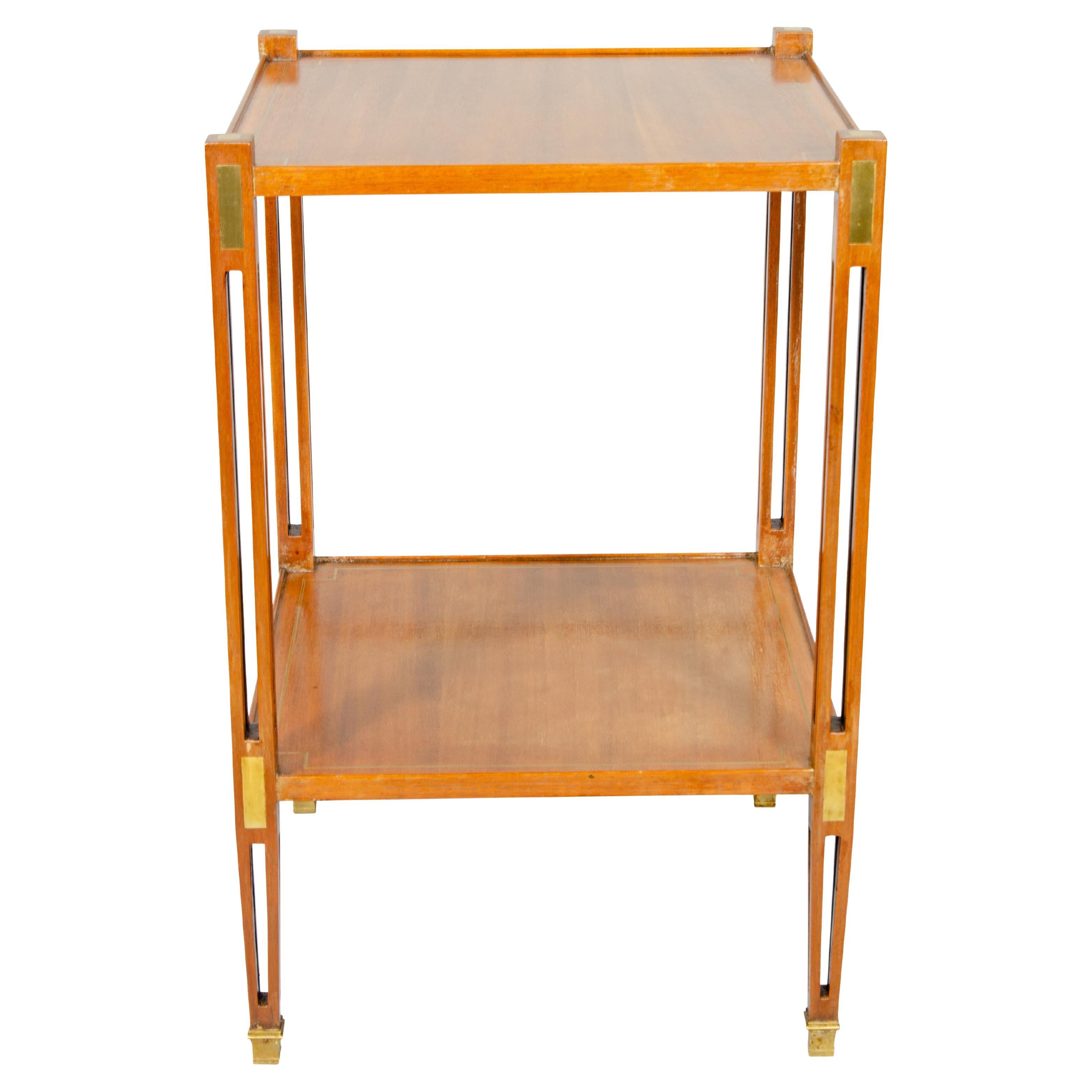 Square top with conforming lower shelf with pierced legs with brass inset panels, square tapered legs.