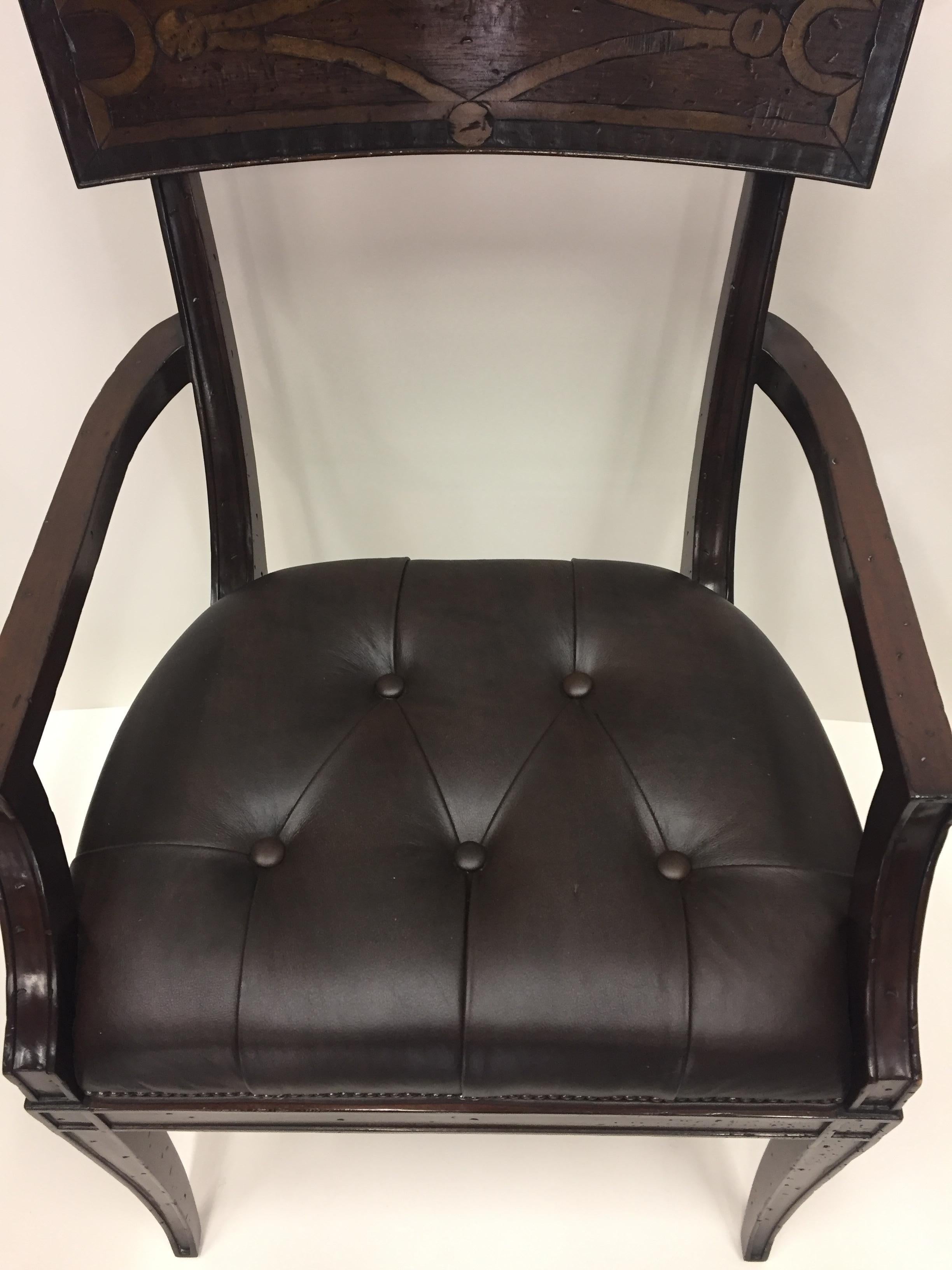 Rich looking Regency style armchair having mahogany carved and inlaid back with elegantly shaped arms and tapered legs, handsomely upholstered with a tufted chocolate brown leather seat.