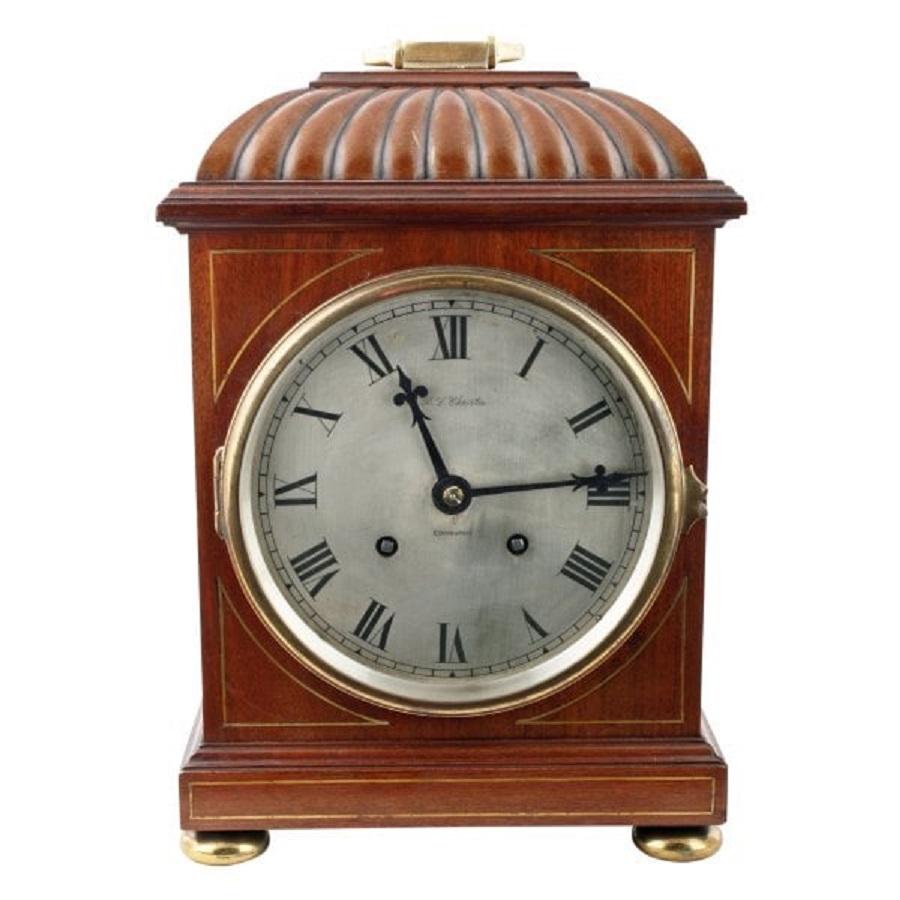 A late 19th to early 20th century Regency style mahogany cased bracket clock.

The clock has an eight day movement that strikes a coiled gong on the hour and half hour.

The silverised dial has Roman numerals and the retailer's name 
