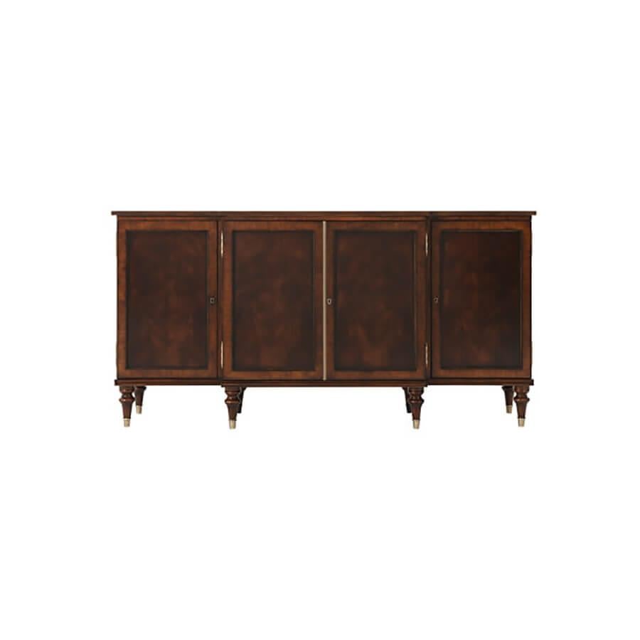 A Regency style mahogany veneered and satinwood crossbanded side cabinet, the breakfront reeded edge top above four doors, the central doors enclosing two drawers and an adjustable shelf, the side doors each enclosing adjustable shelves, on turned