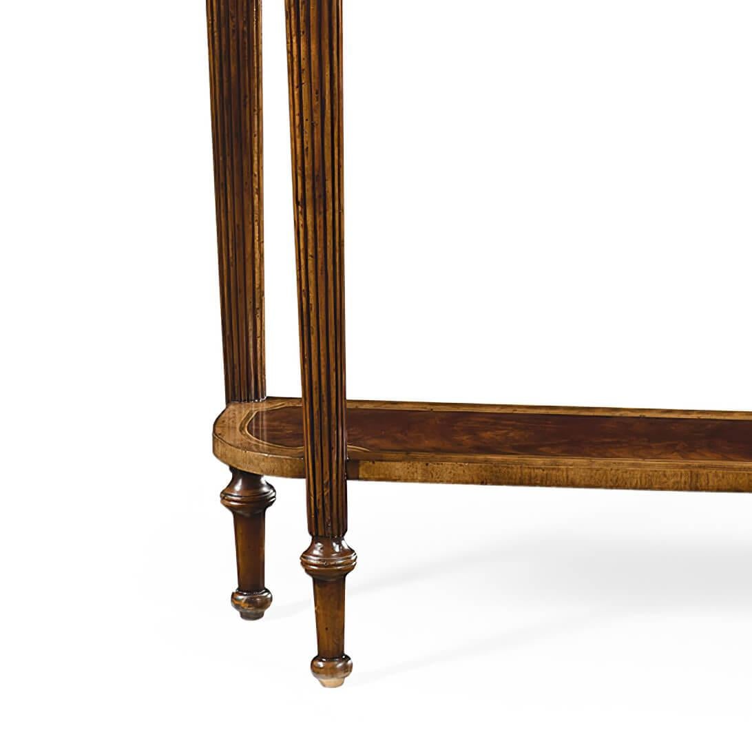 Late Regency style mahogany console table with an antiqued finish, two drawers above a shaped under tier set between elegant fluted tapering legs topped with paterae.

Dimensions: 54