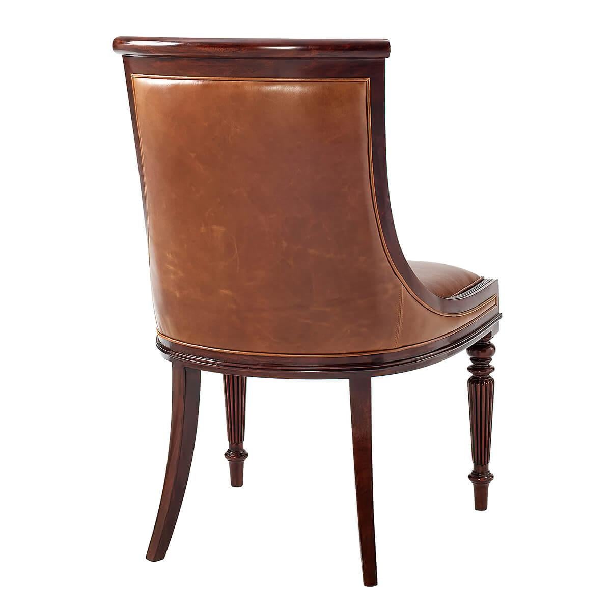A Regency style mahogany dining chair with a hand-carved mahogany scoop back, the paneled and upholstered back above an upholstered seat, on turned and reeded legs.
Dimensions: 22.5