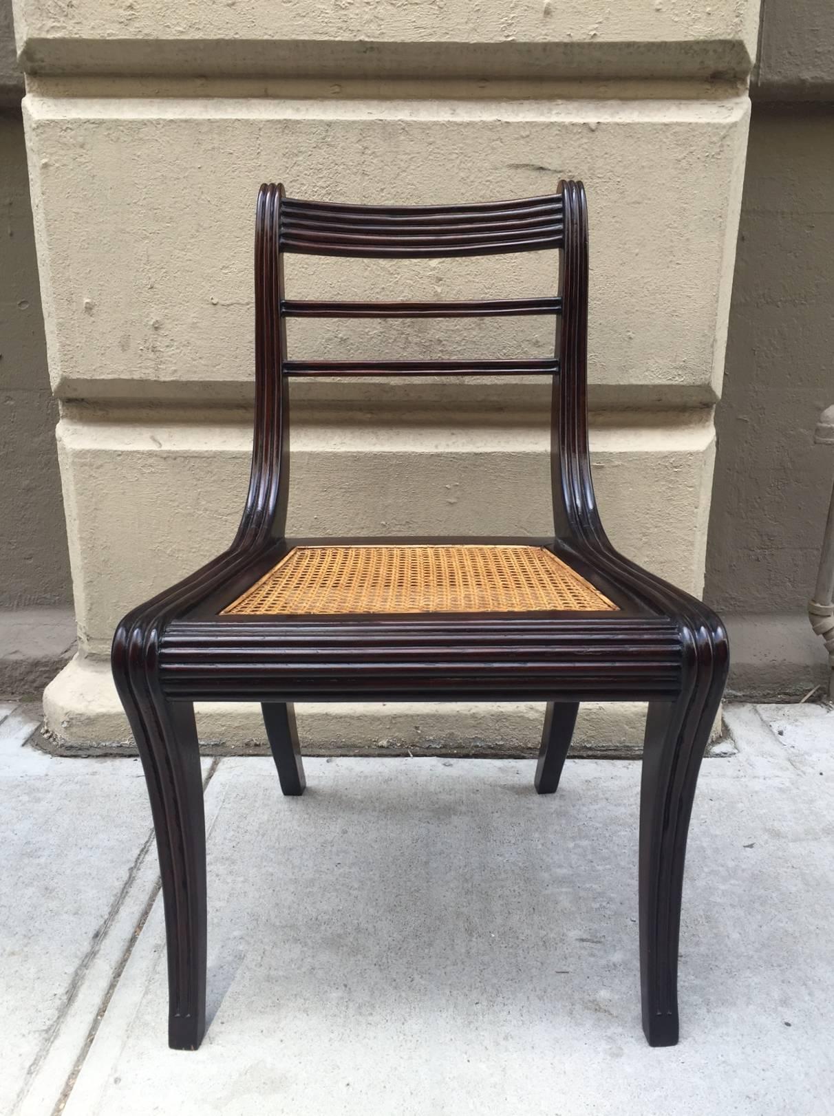 Set of 6 solid mahogany Regency style mahogany carved dining chairs with caned seats.